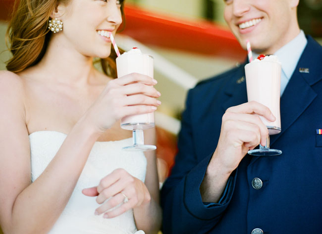 bride and groom drinking milkshakes