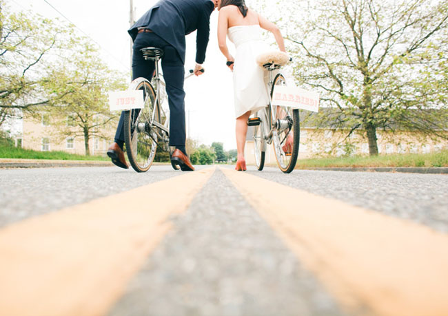 bride and groom on bicycles