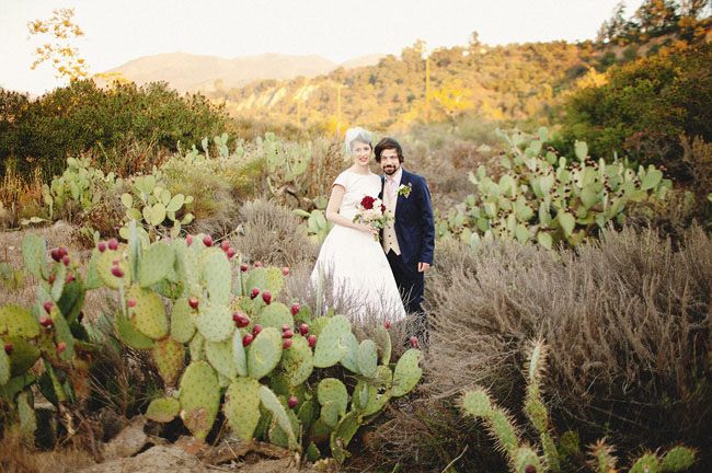 bride and groom in cactus field