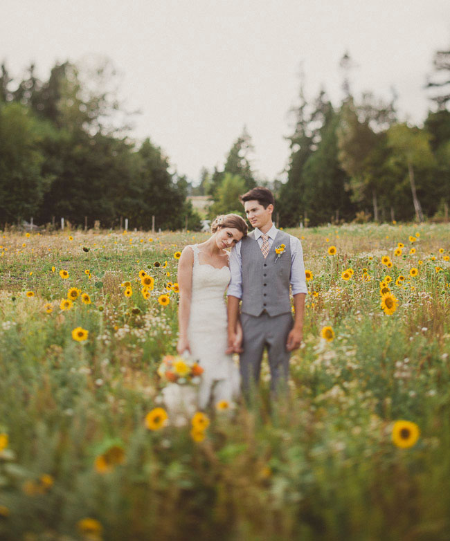 bride and groom in sunflower field