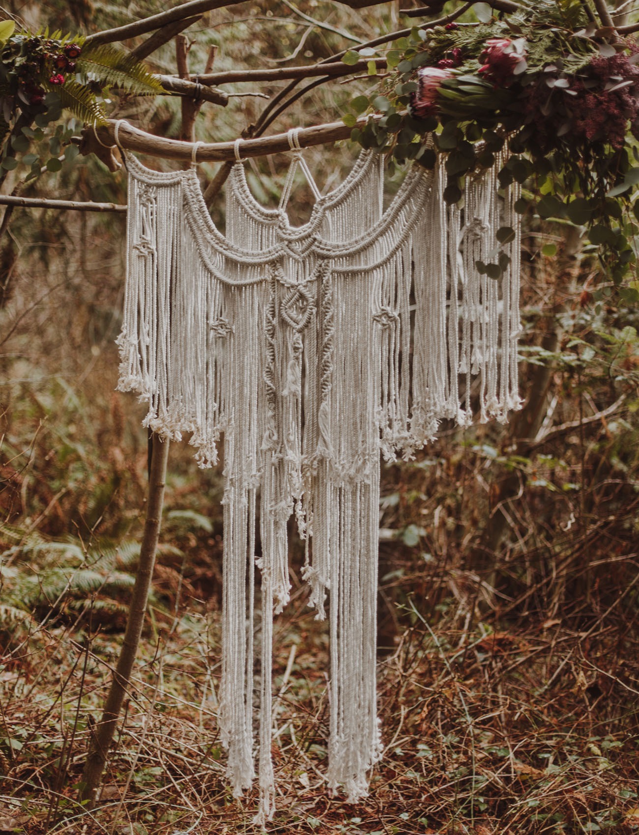 macrame DIY wedding backdrop hanging in the woods