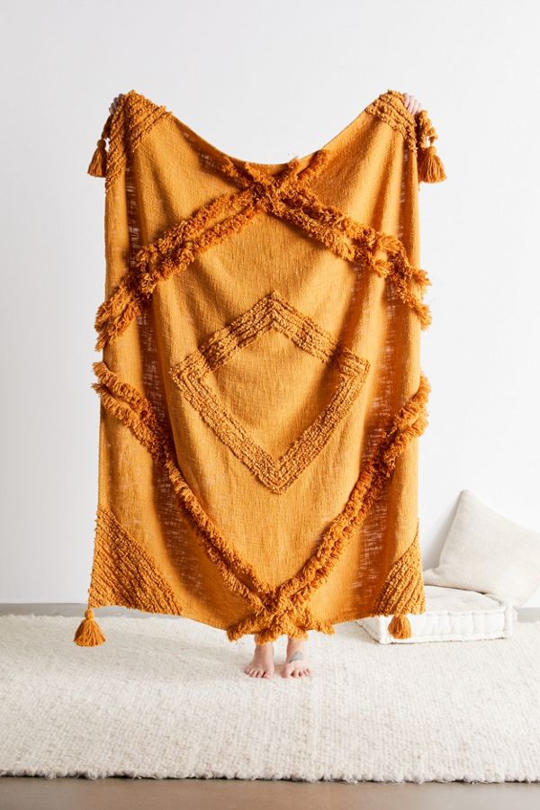 This throw comes in mustard, navy, and cream!