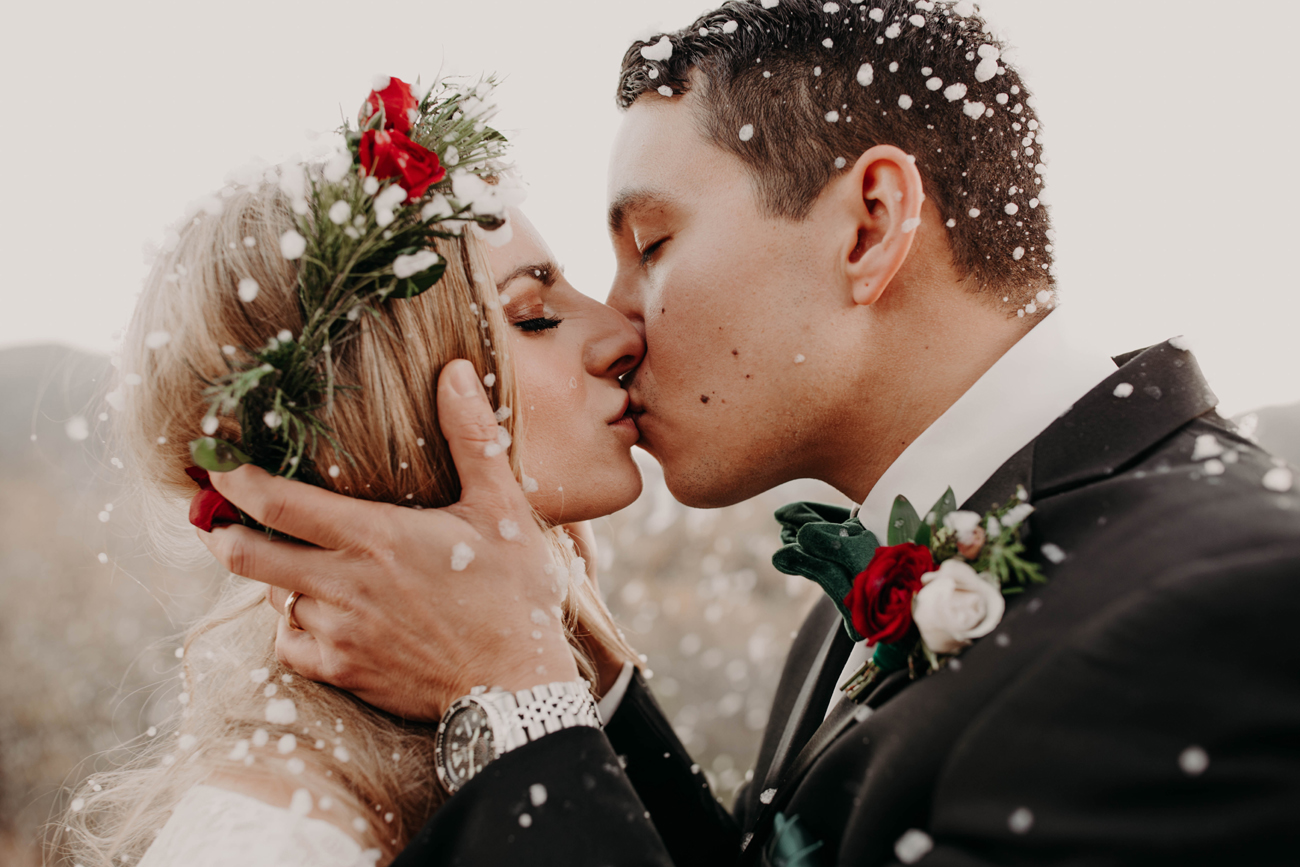 Bride and Groom Kiss in the Snow