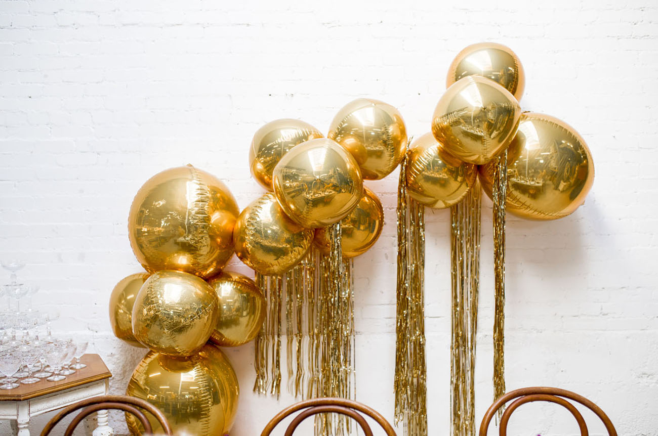 gold fringe balloon arch