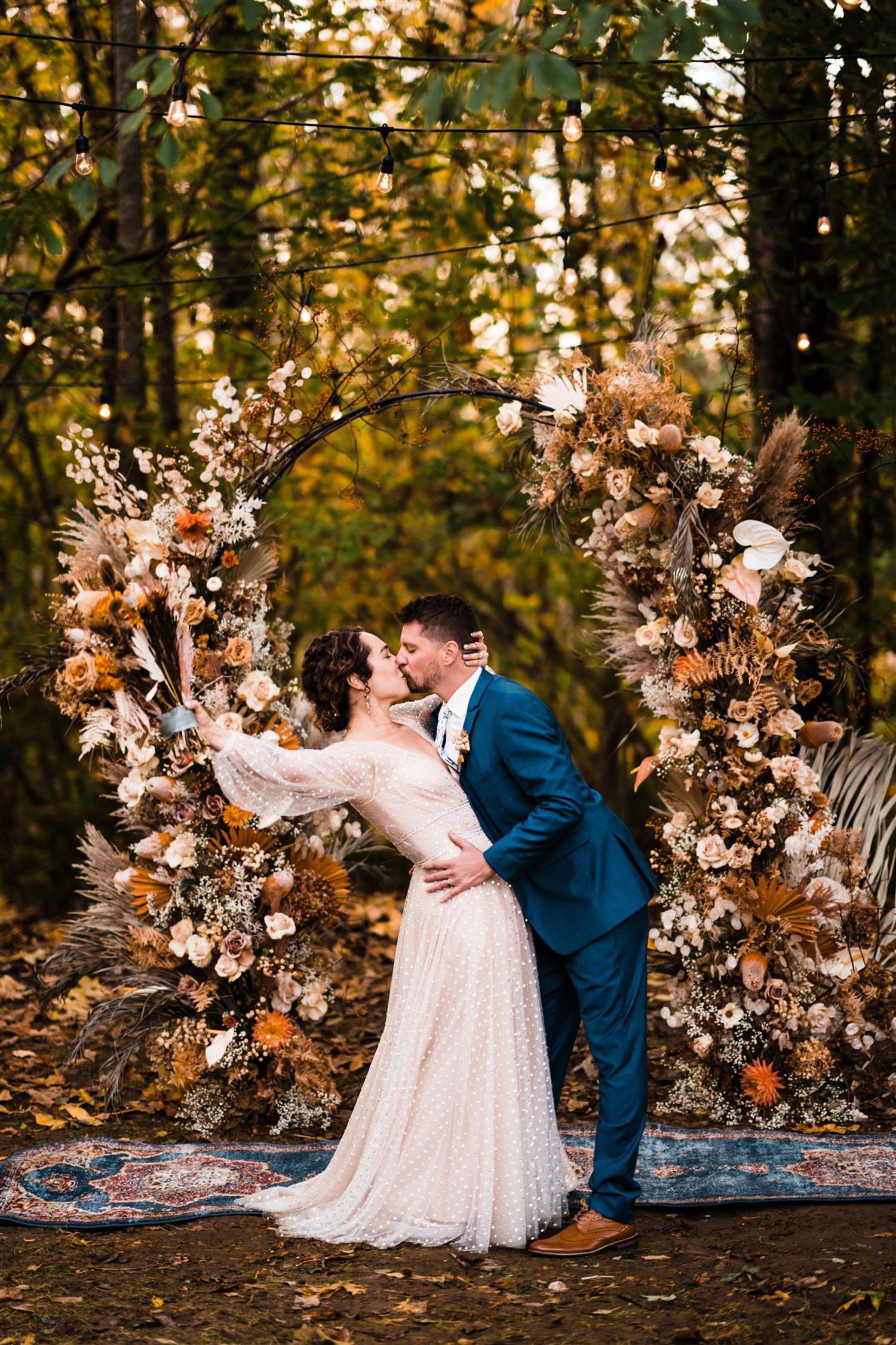 intimate backyard wedding with fall floral backdrop