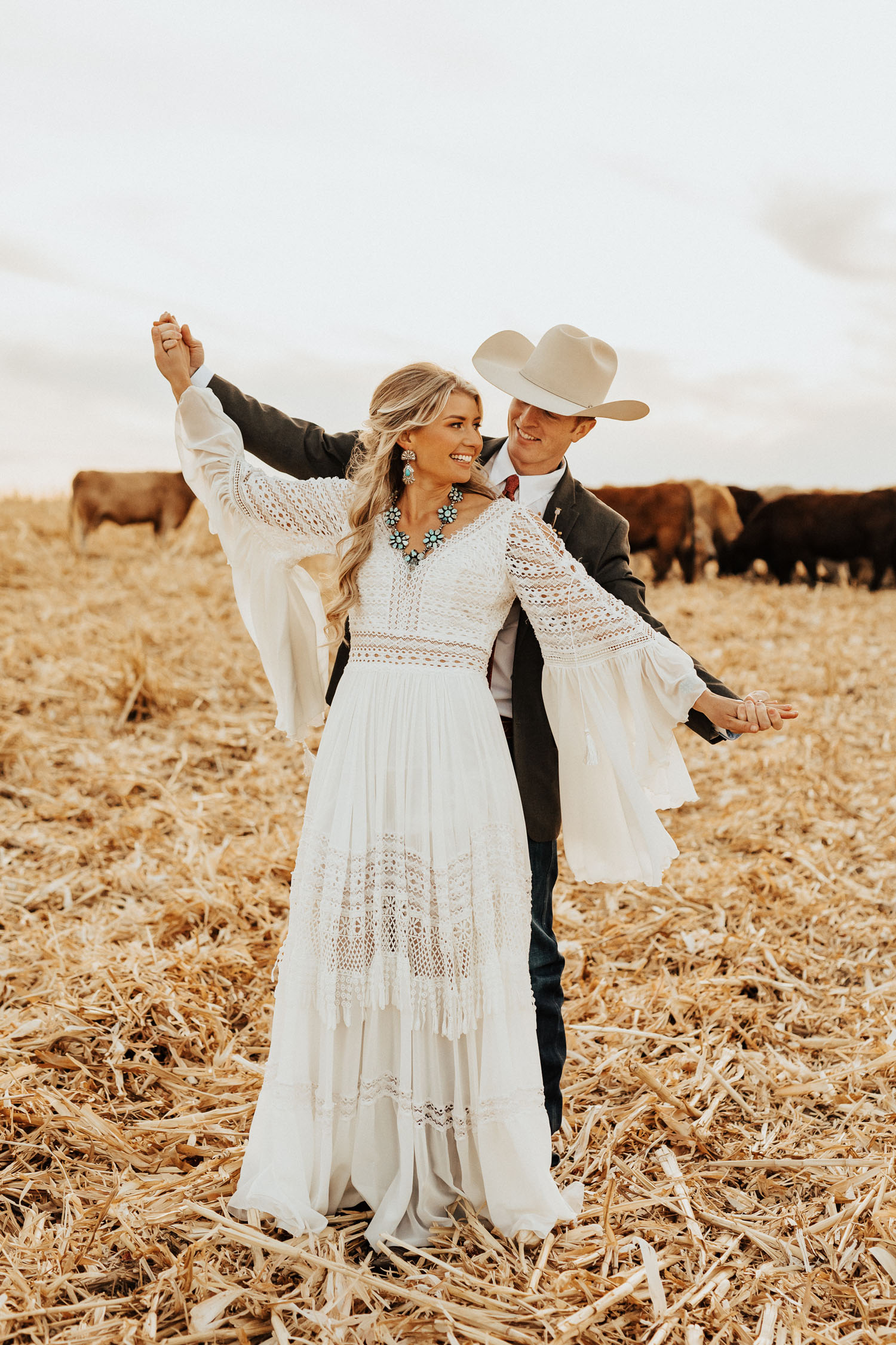 groom with cowboy hat and boho bride