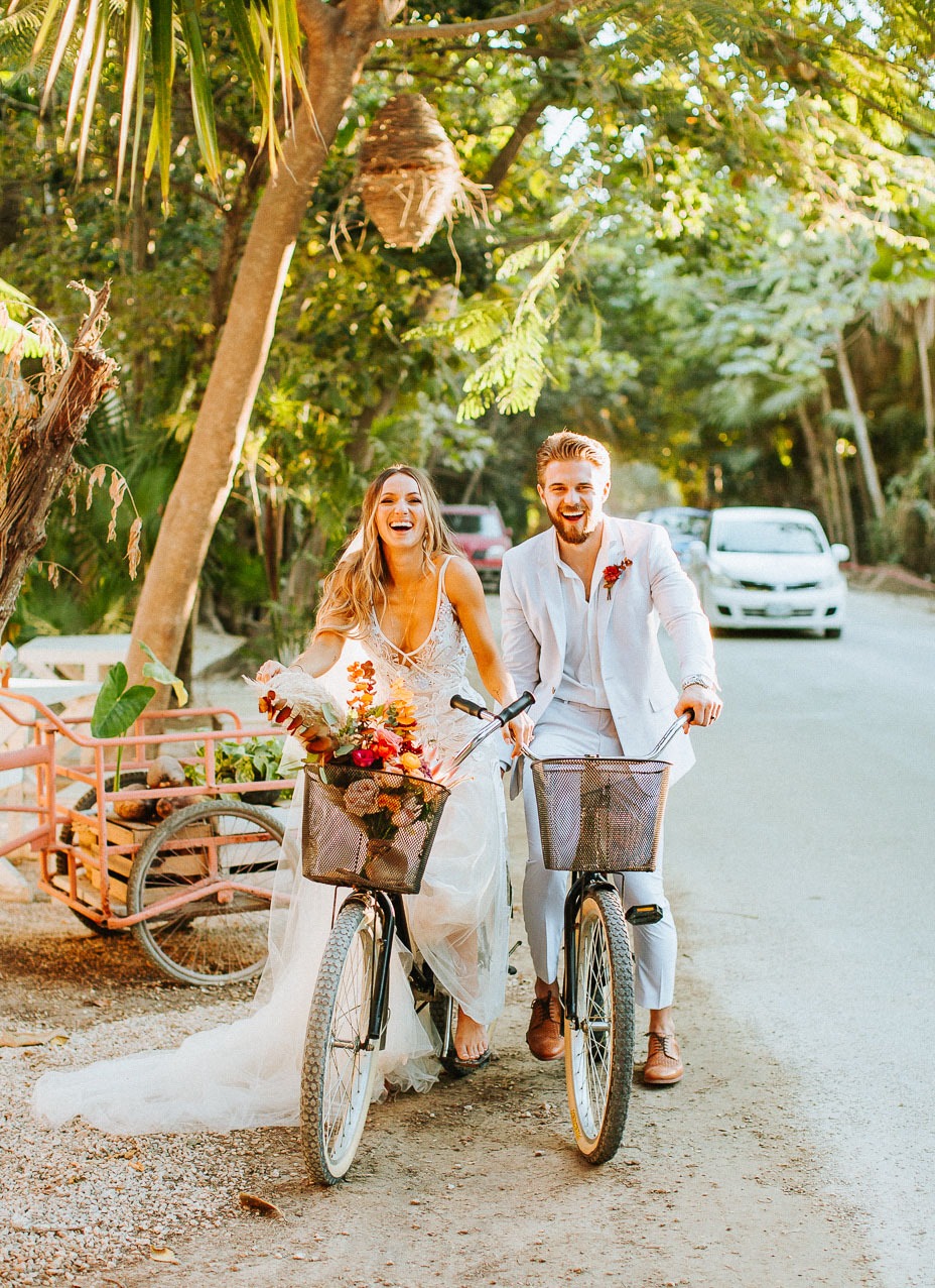 couple going for a tropical bike ride at their destination wedding location