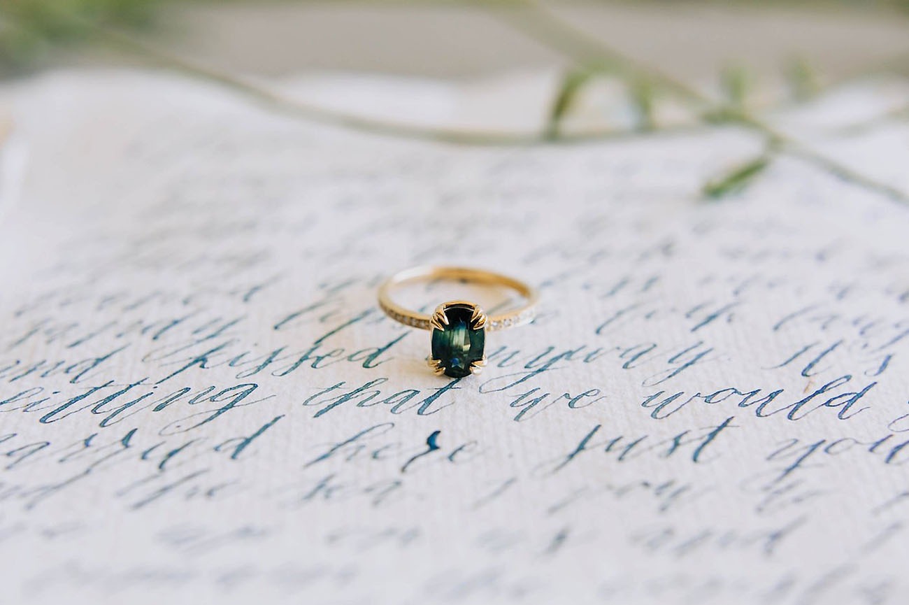 dark green gemstone non diamond engagement ring with a simple gold band