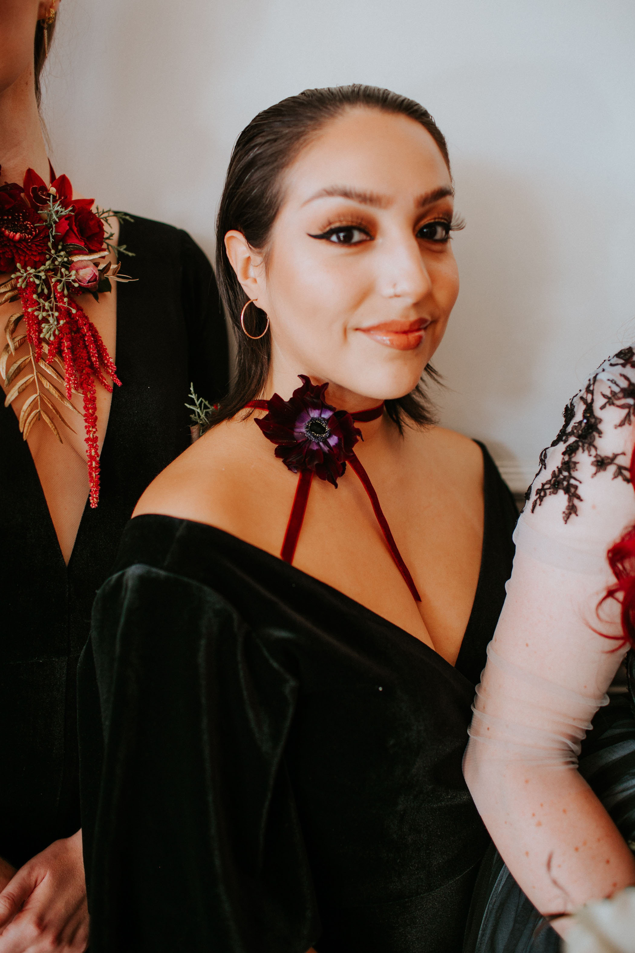 Black velvet bridesmaid dress with red flower choker
