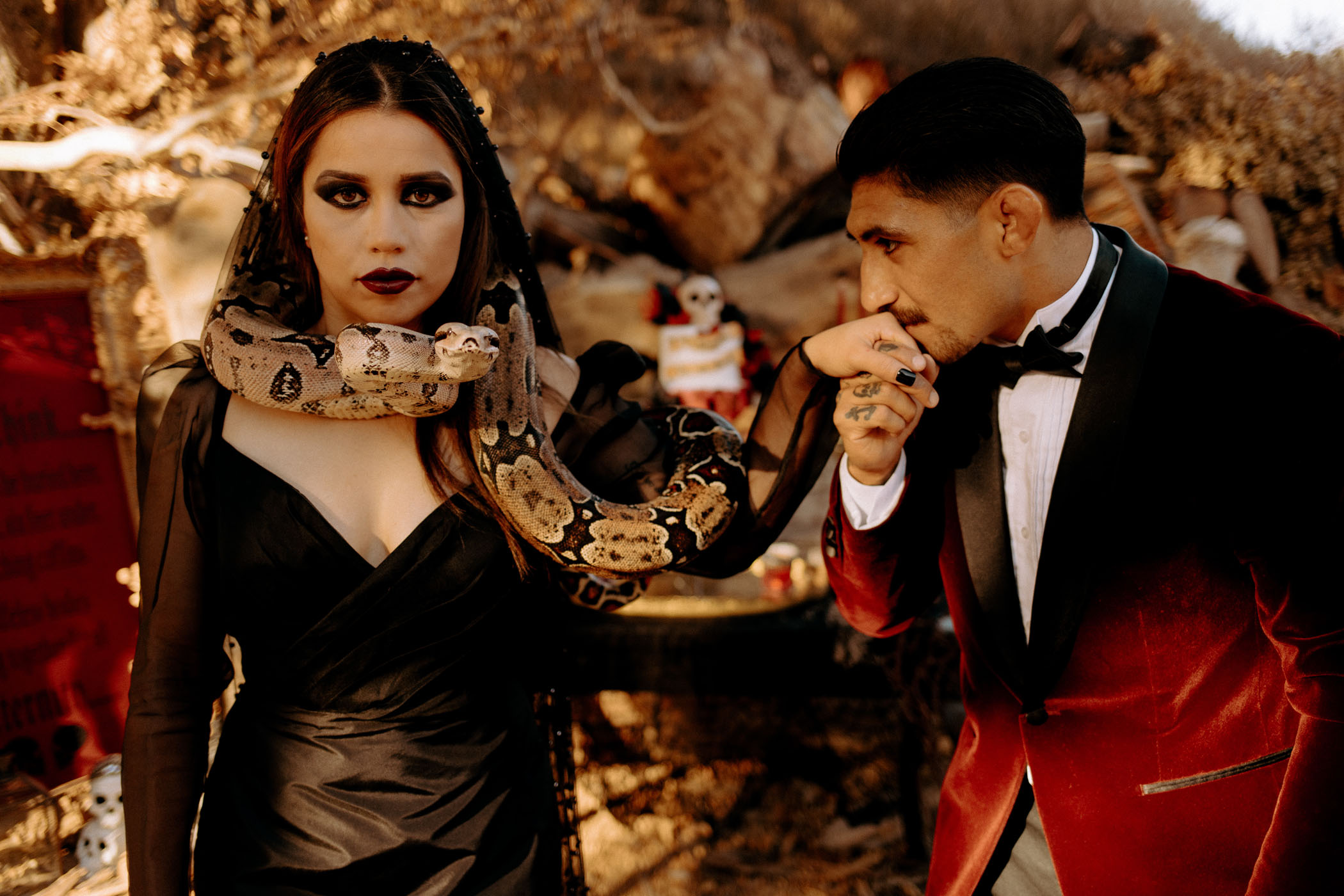 Bride in black dress with snake wrapped around her neck 