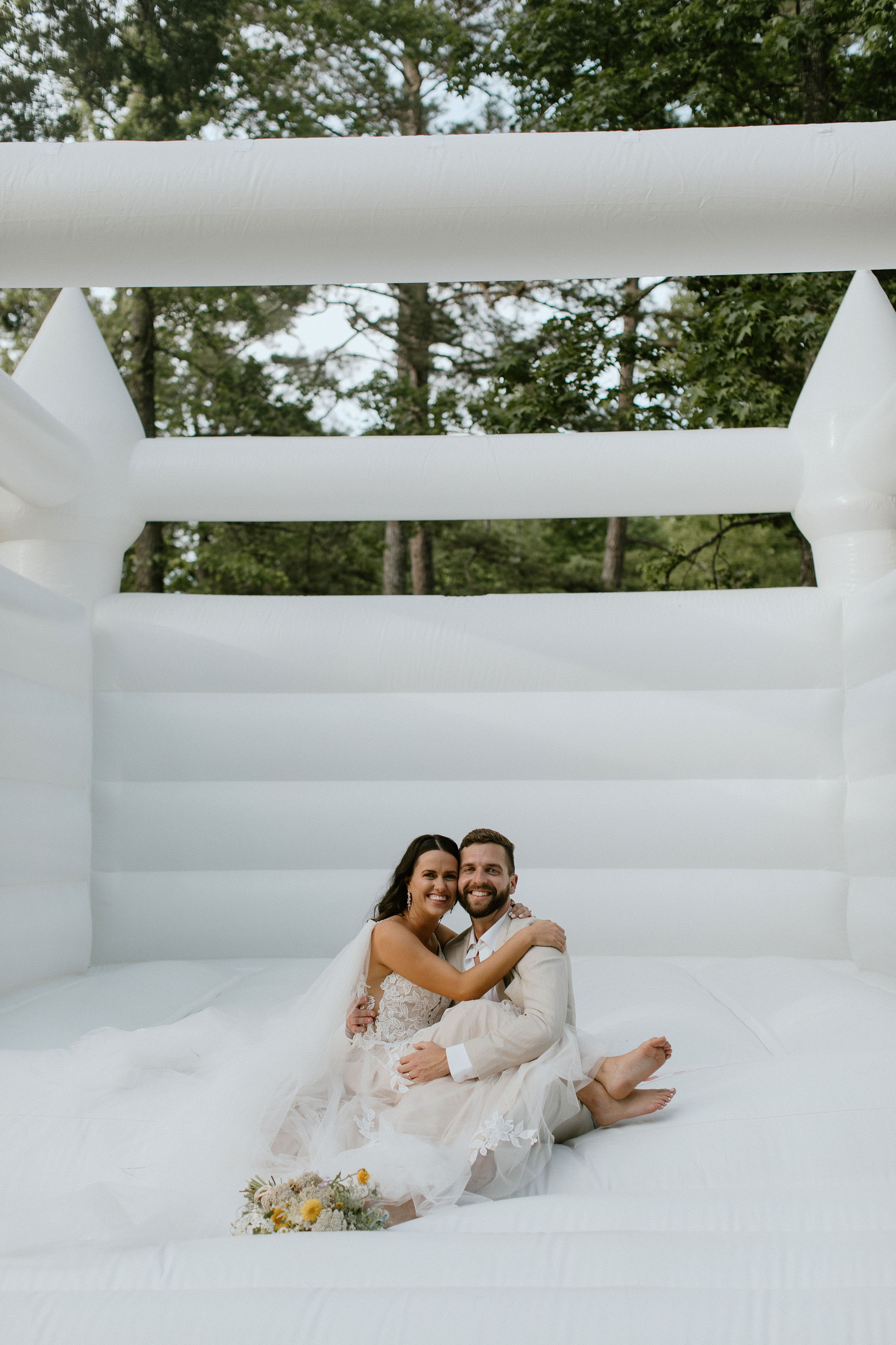 Bride and groom in bounce house on their wedding day