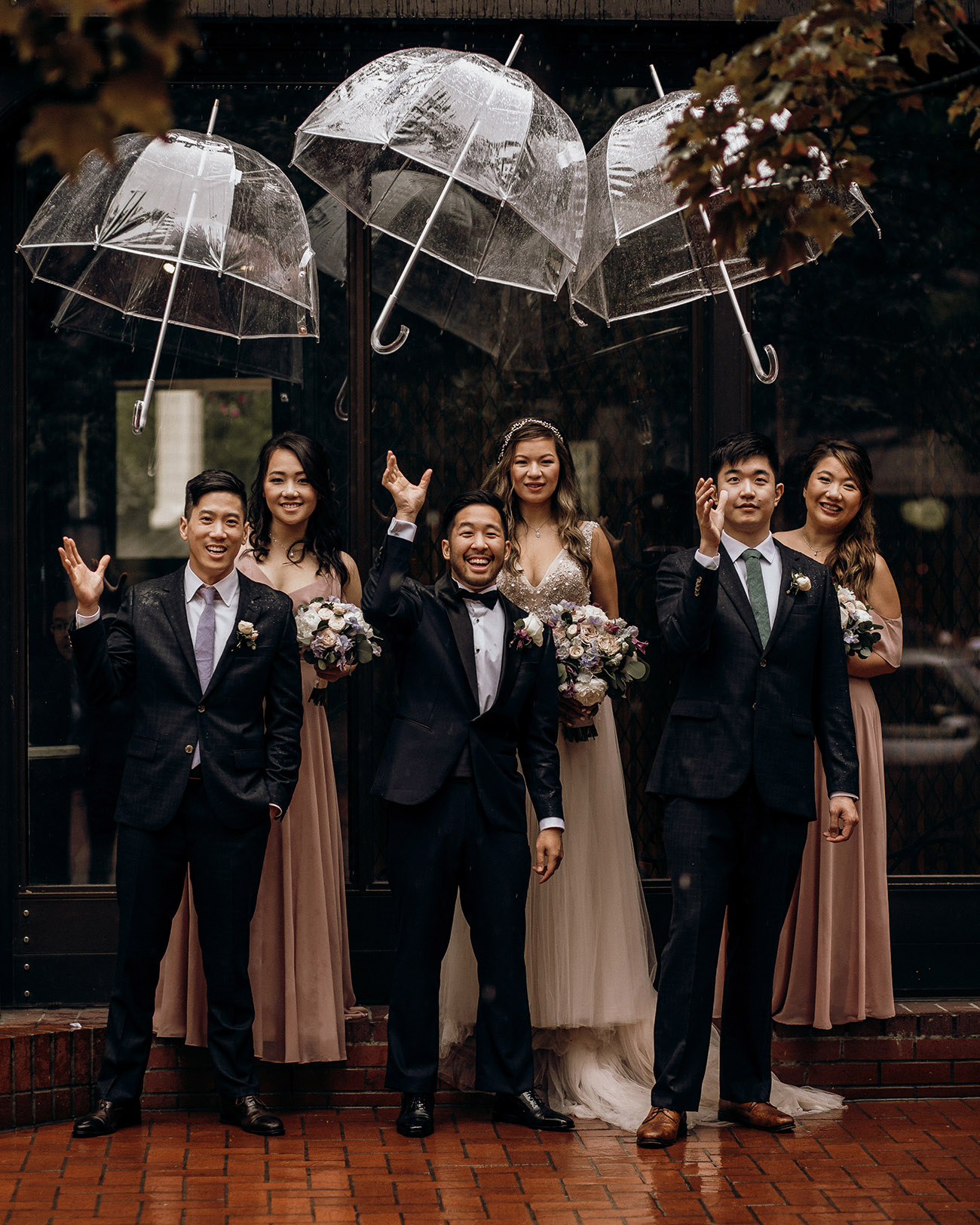 bridal party with umbrellas for rainy wedding