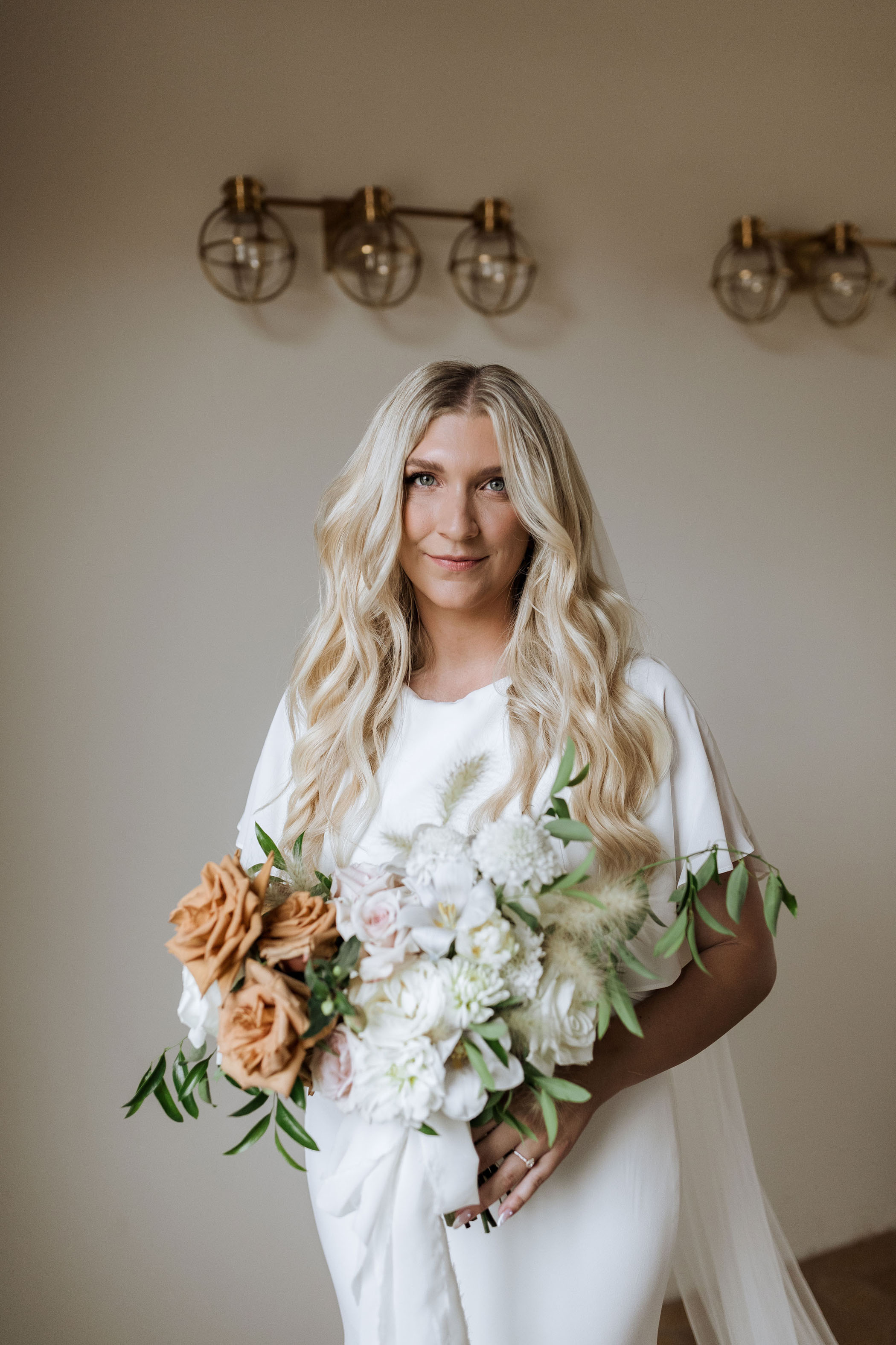 bride with long blonde hair in a silk wedding gown and simple makeup