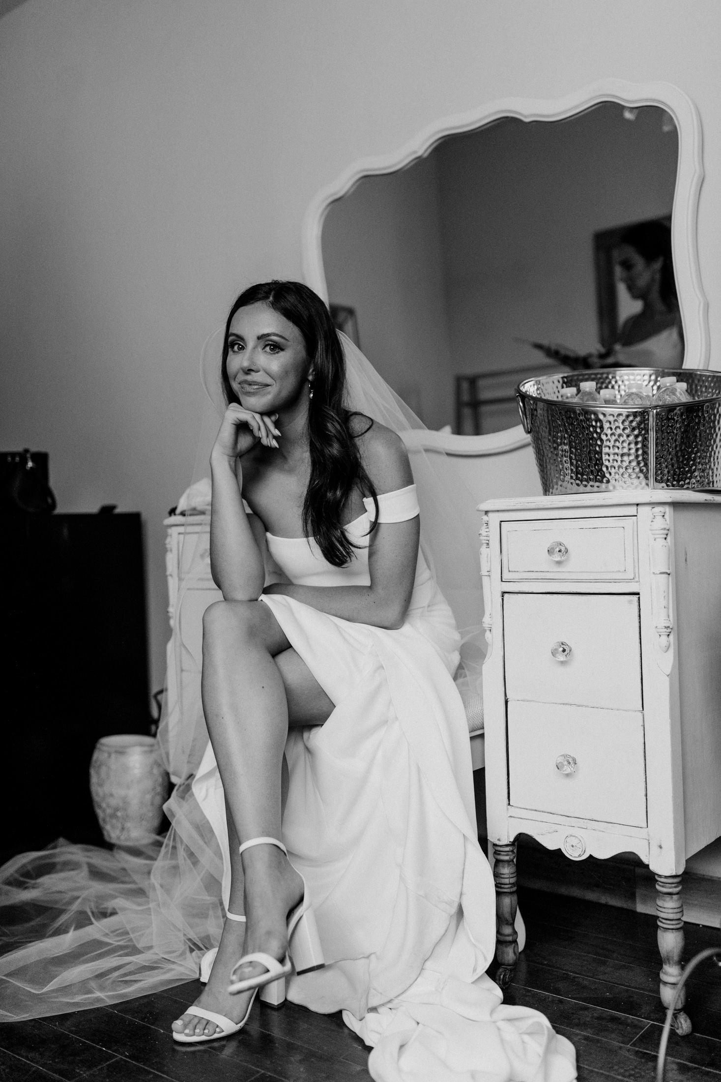 Black and white photo of a bride in her dressing room 