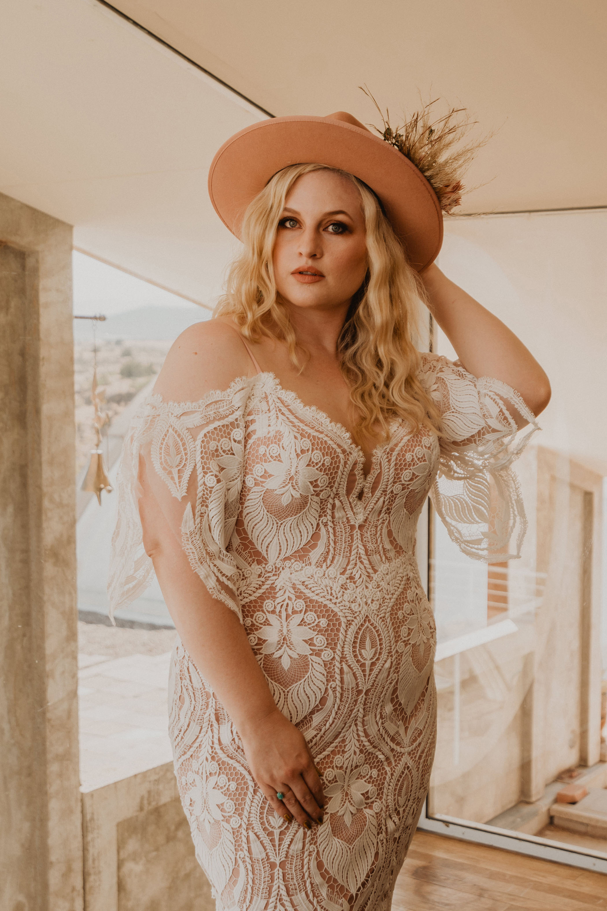bride in lacey off the shoulder dress and western hat