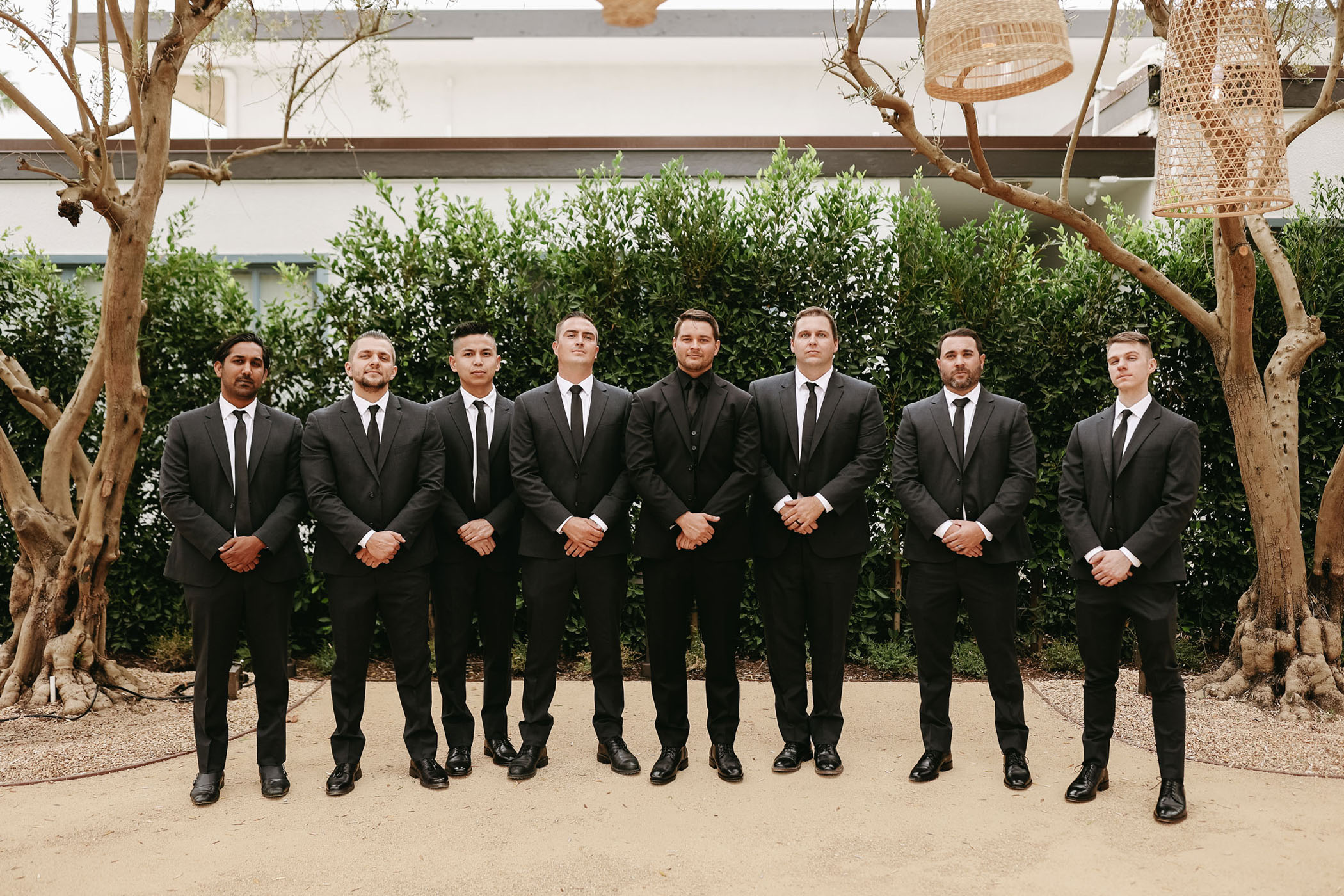 groomsmen and groom in all-black suits