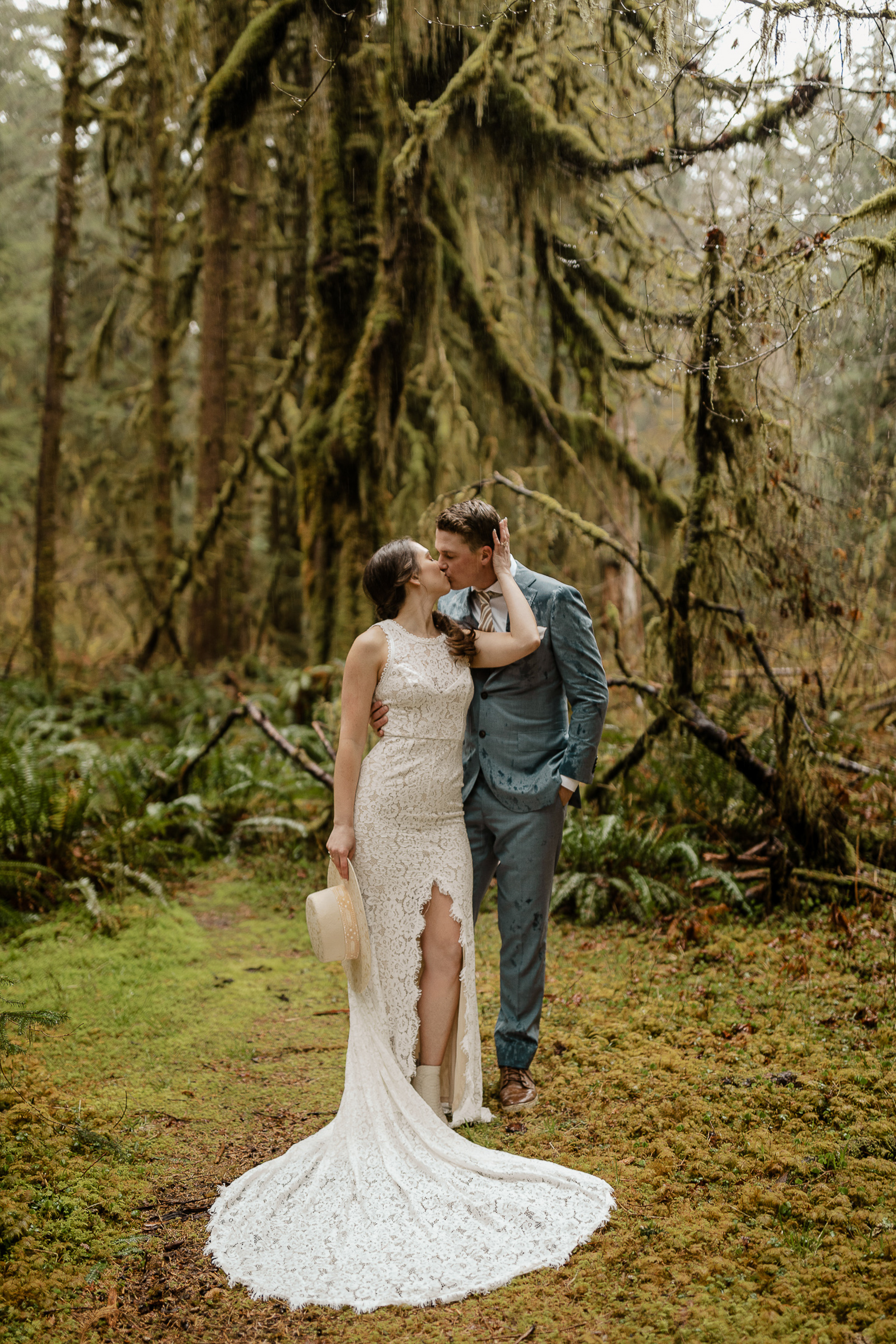 Bride and groom kissing in a rainforest
