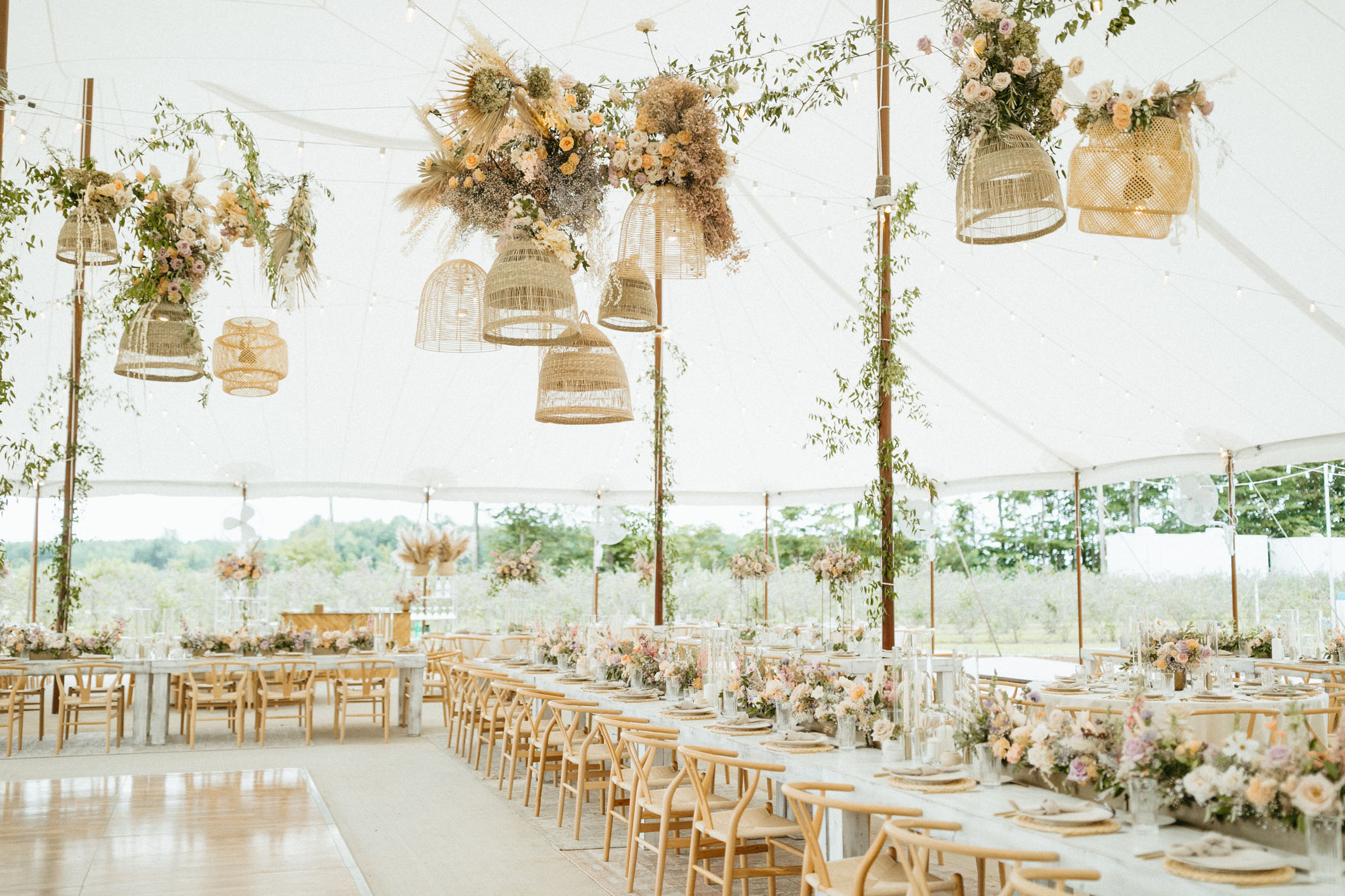 white and neutral wedding reception underneath white tent