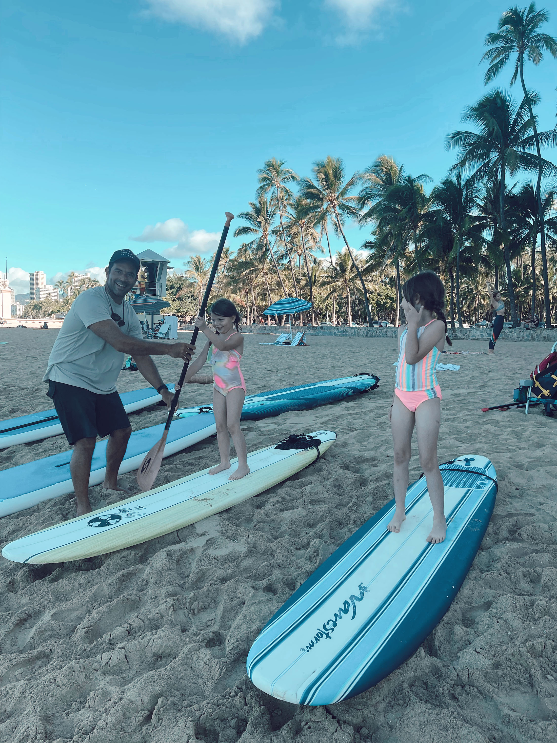 learning how to paddle board at Kaimana Beach Hotel