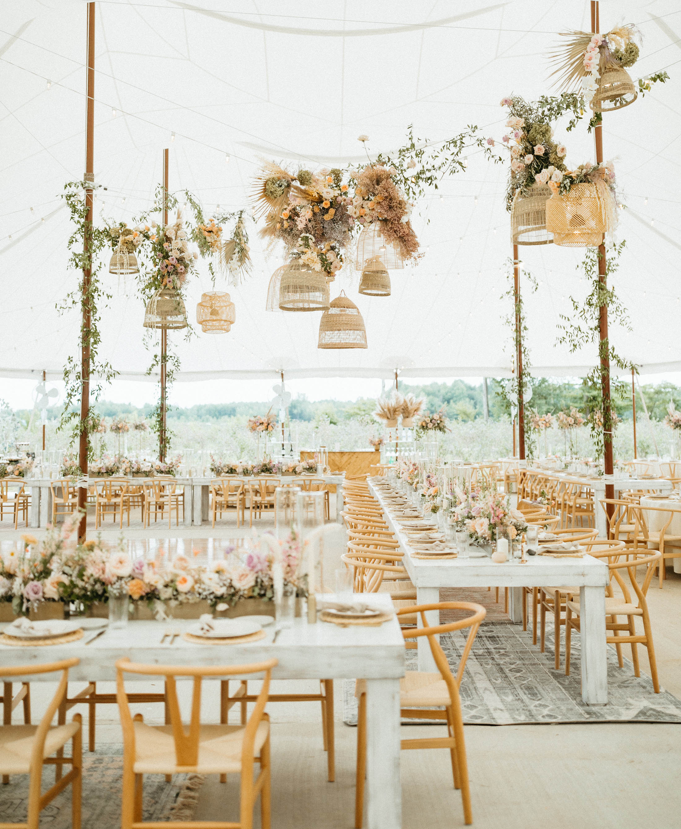 wedding tent with flowers and baskets hanging from the ceiling