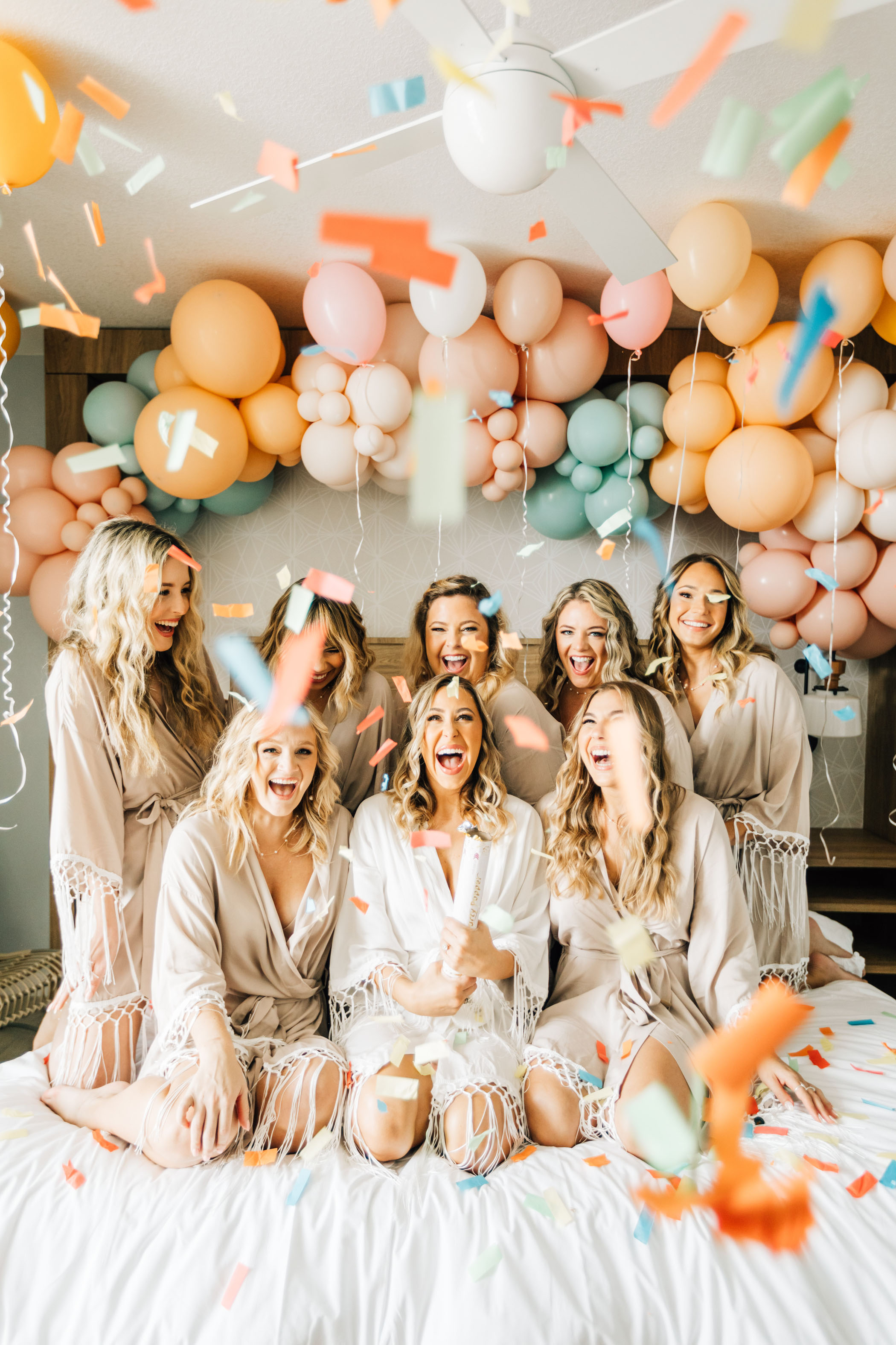 Bridesmaids popping confetti while getting ready