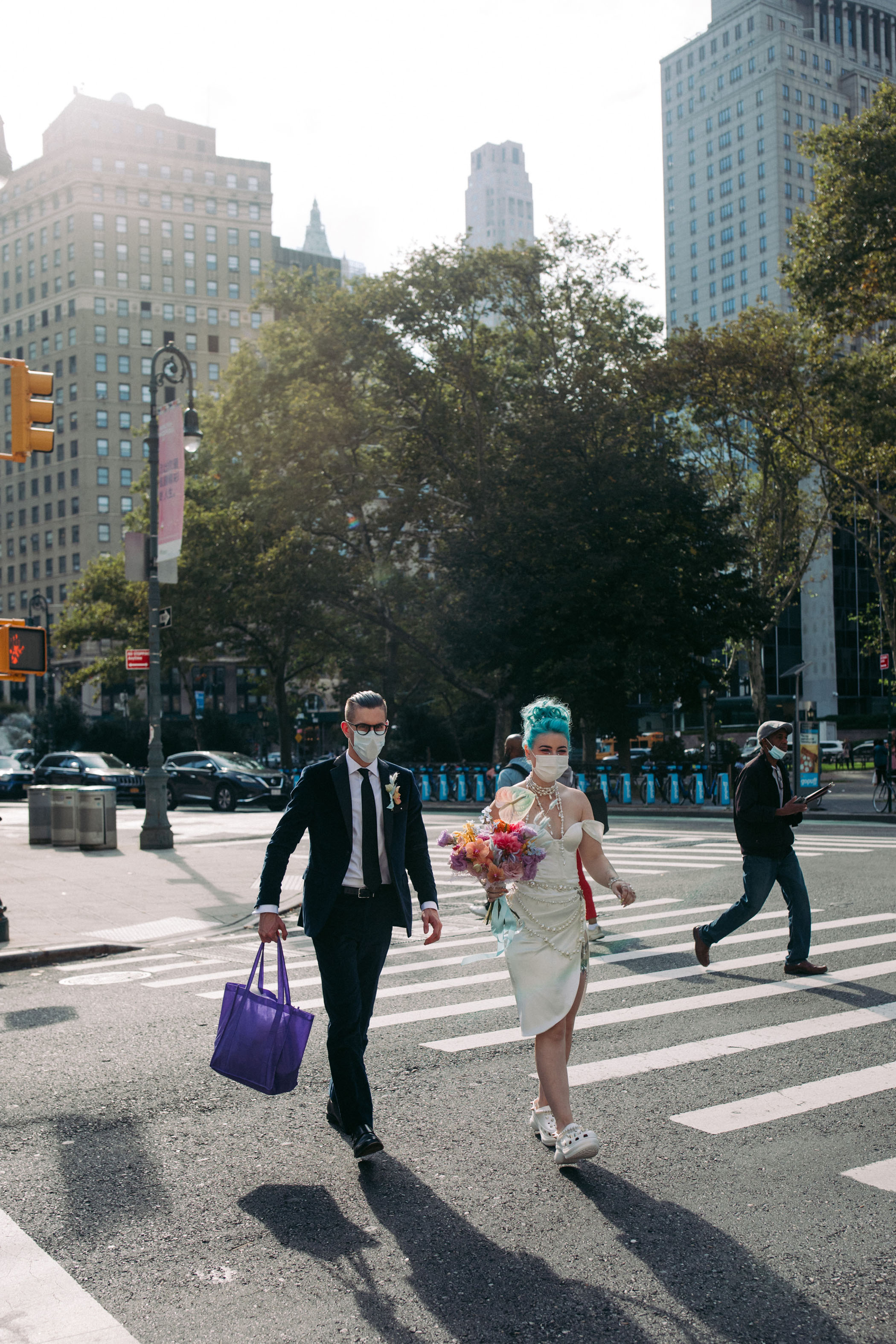 Bride and groom walking along New York crosswalk