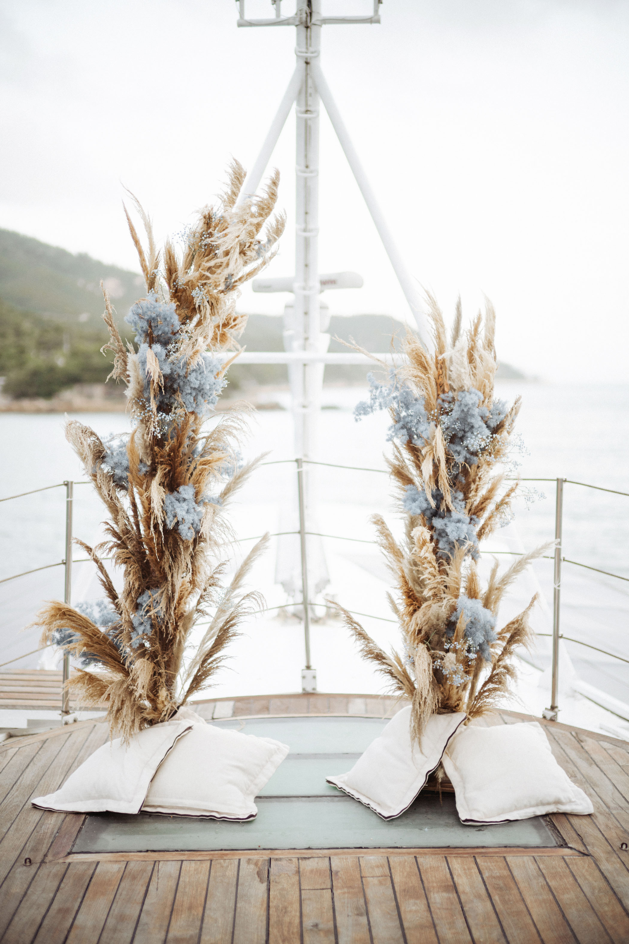 Pampas grass and blue flower yacht wedding decor