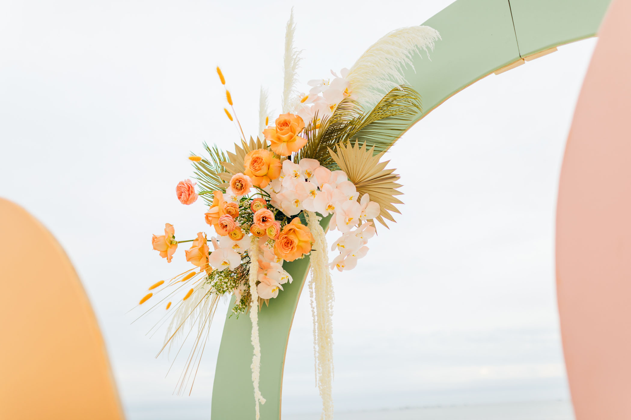 Tropical florals on wedding arch