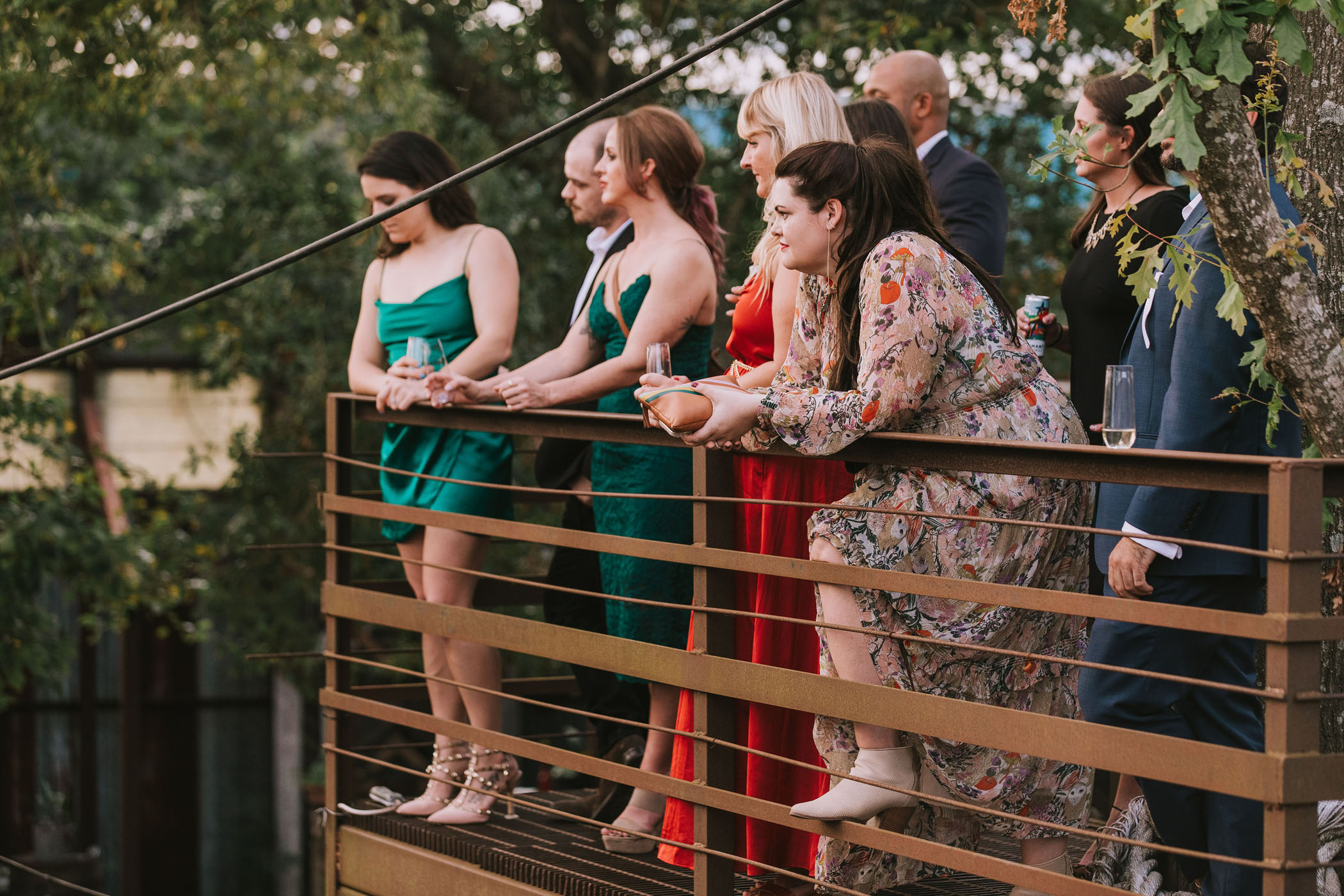 Wedding ceremony guests watching from rail