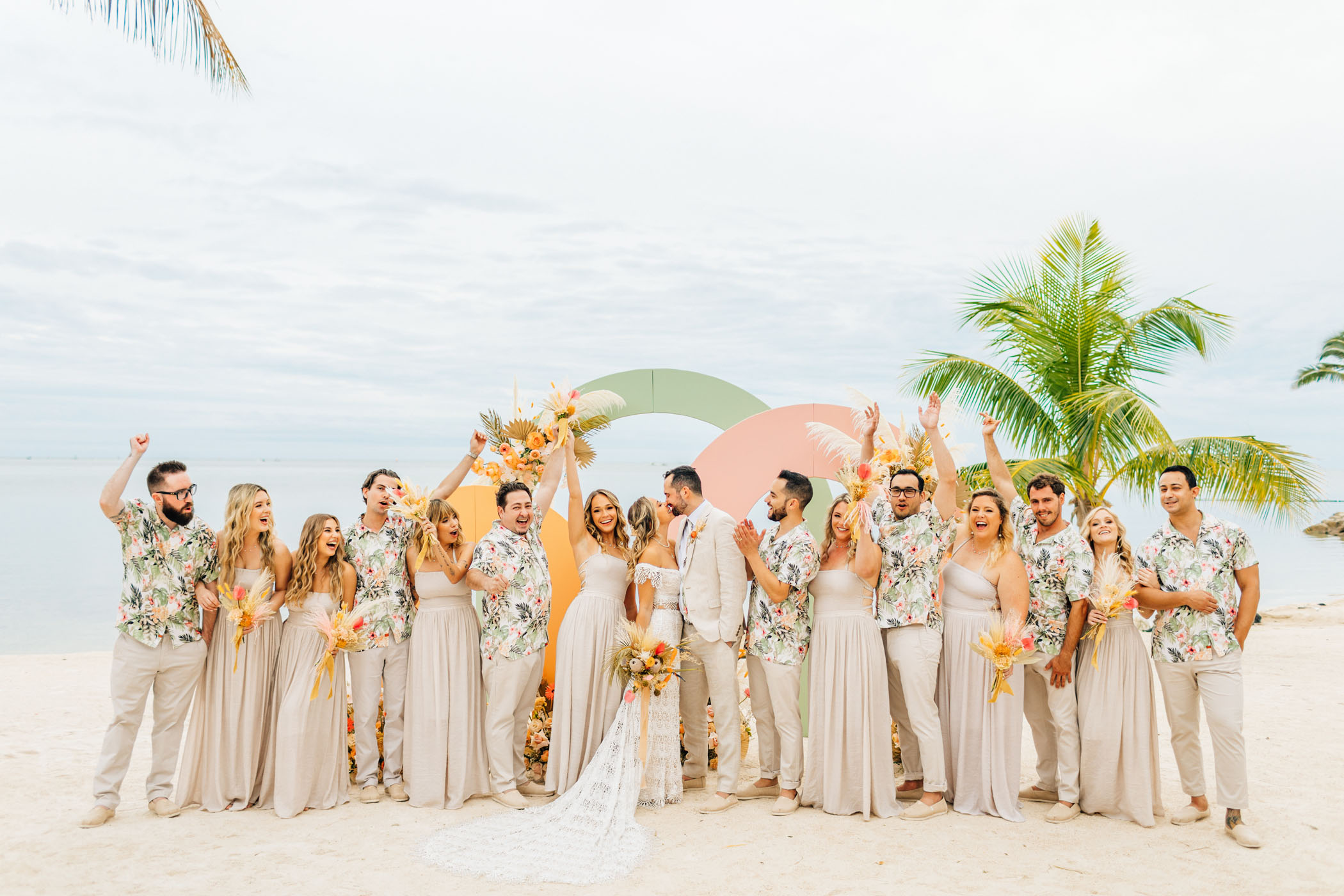 Wedding party in floral shirts and tan dresses