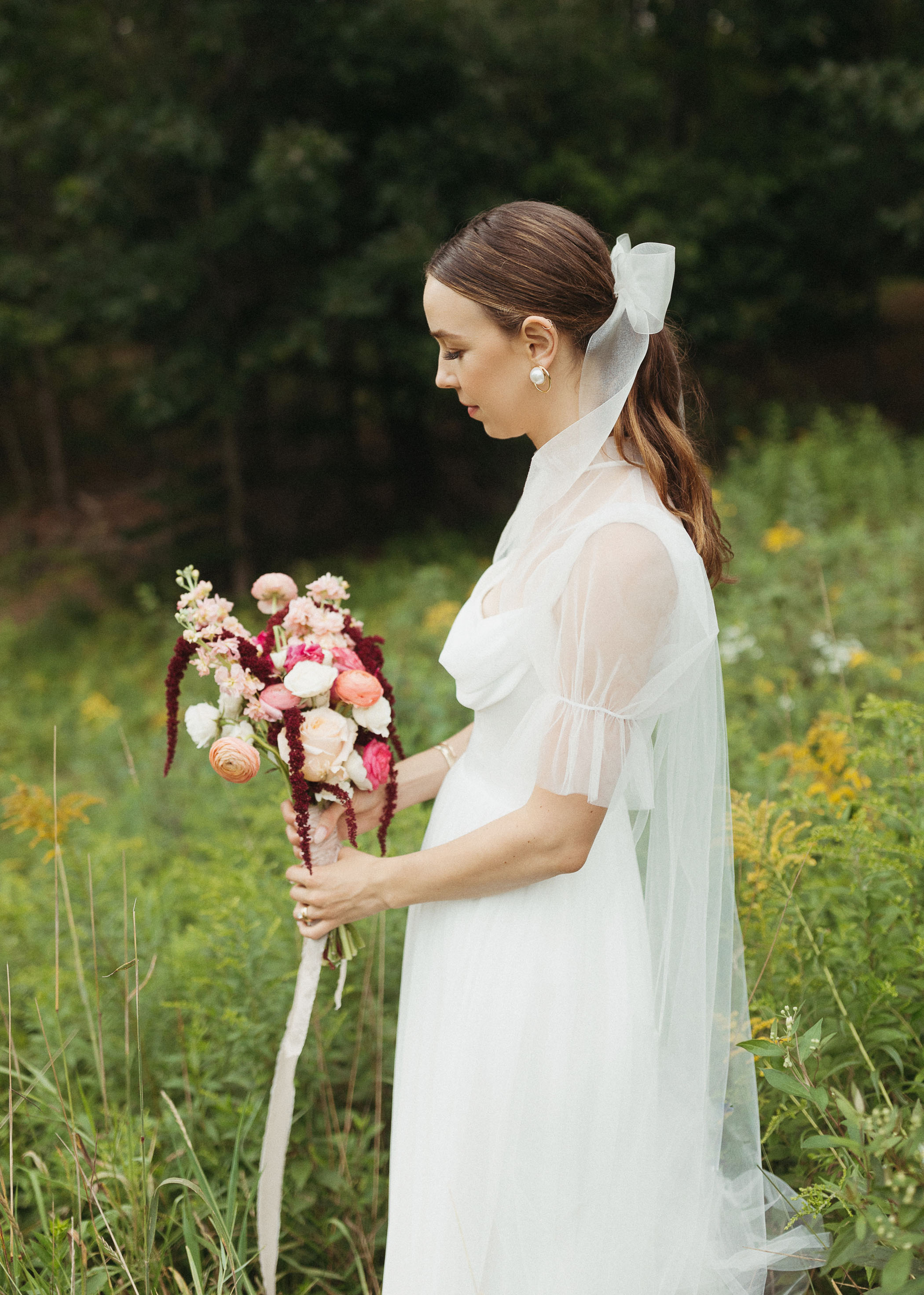 Bride holding pink and red bouquet