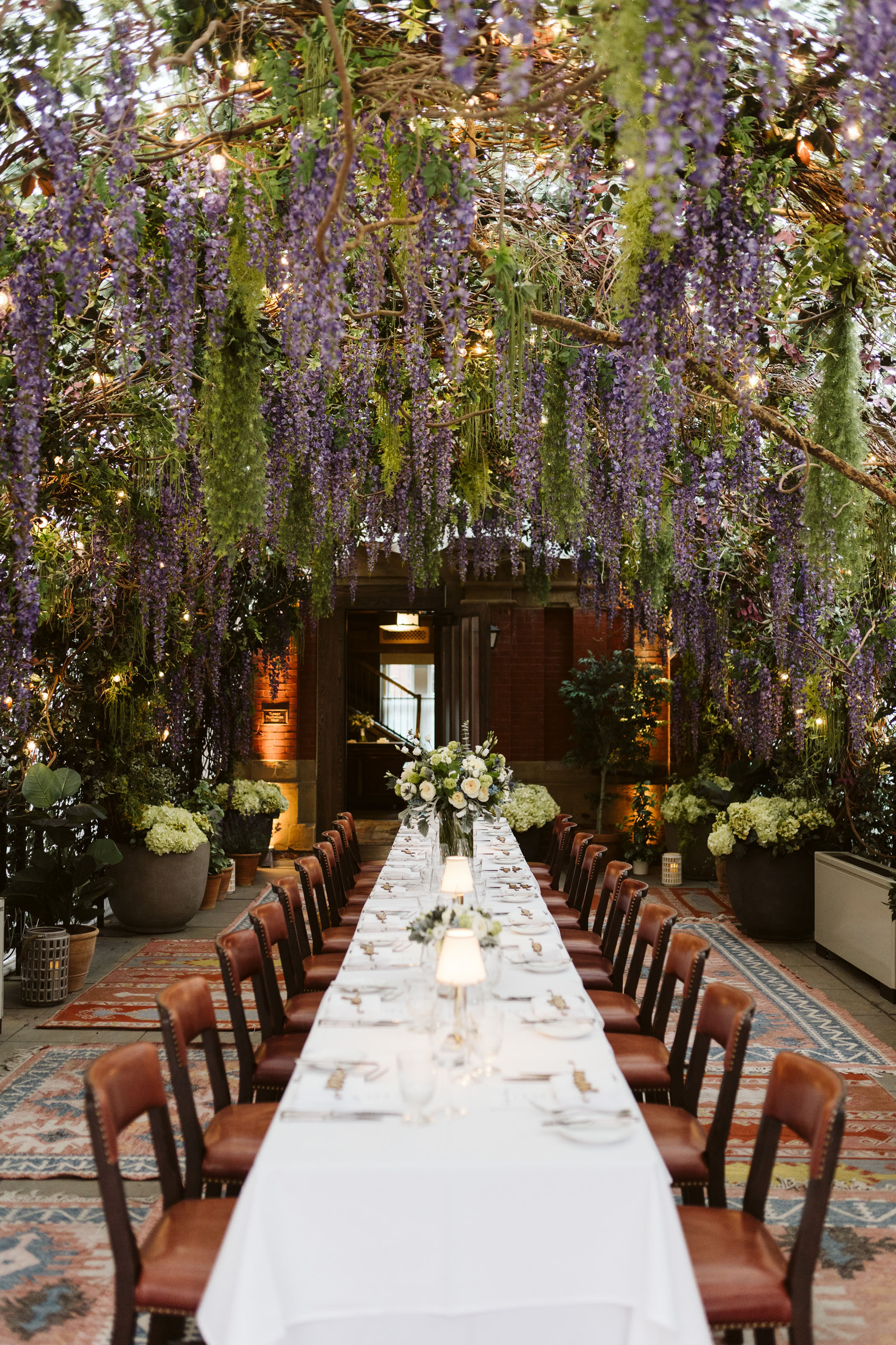 Indoor wedding reception with purple wisteria