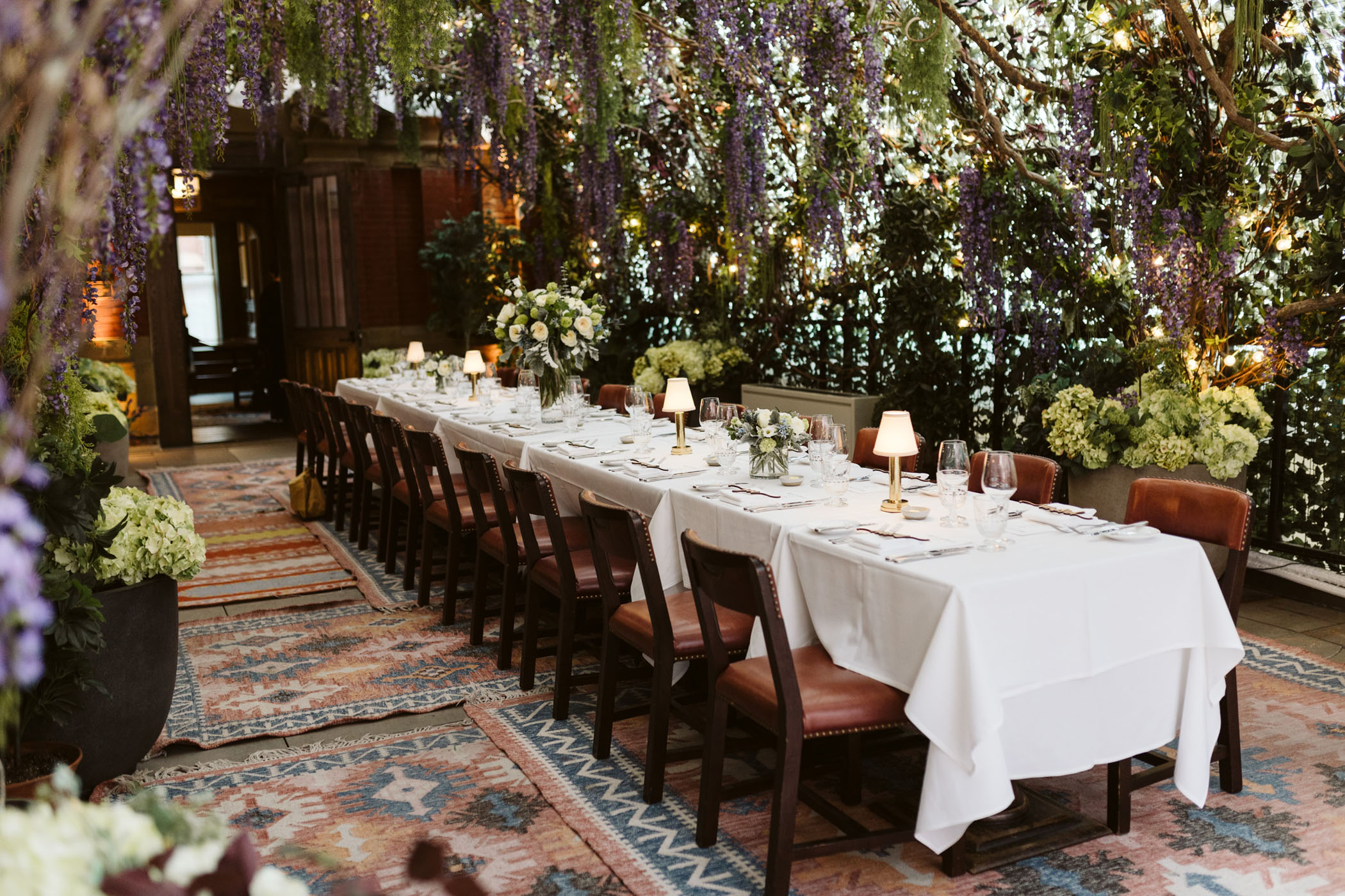Indoor wedding reception with purple wisteria