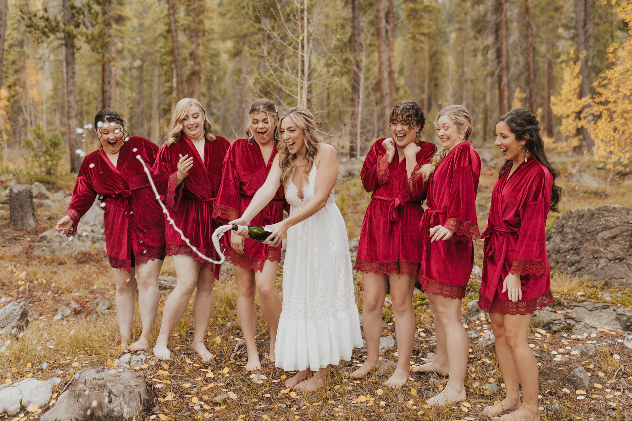 bridesmaid matching red robes and champagne pop