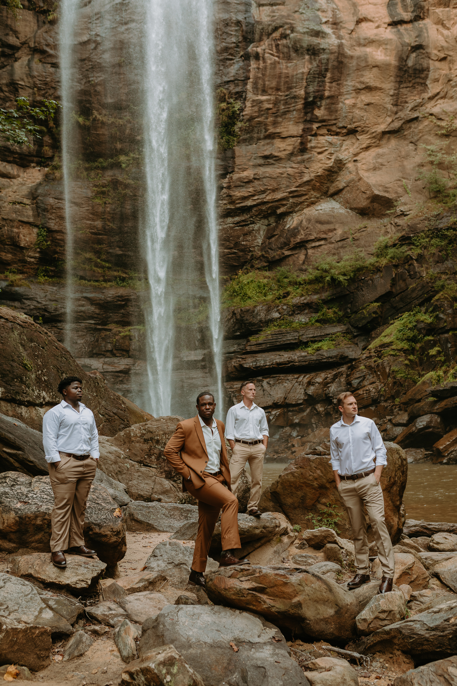 groomsmen underneath waterfall