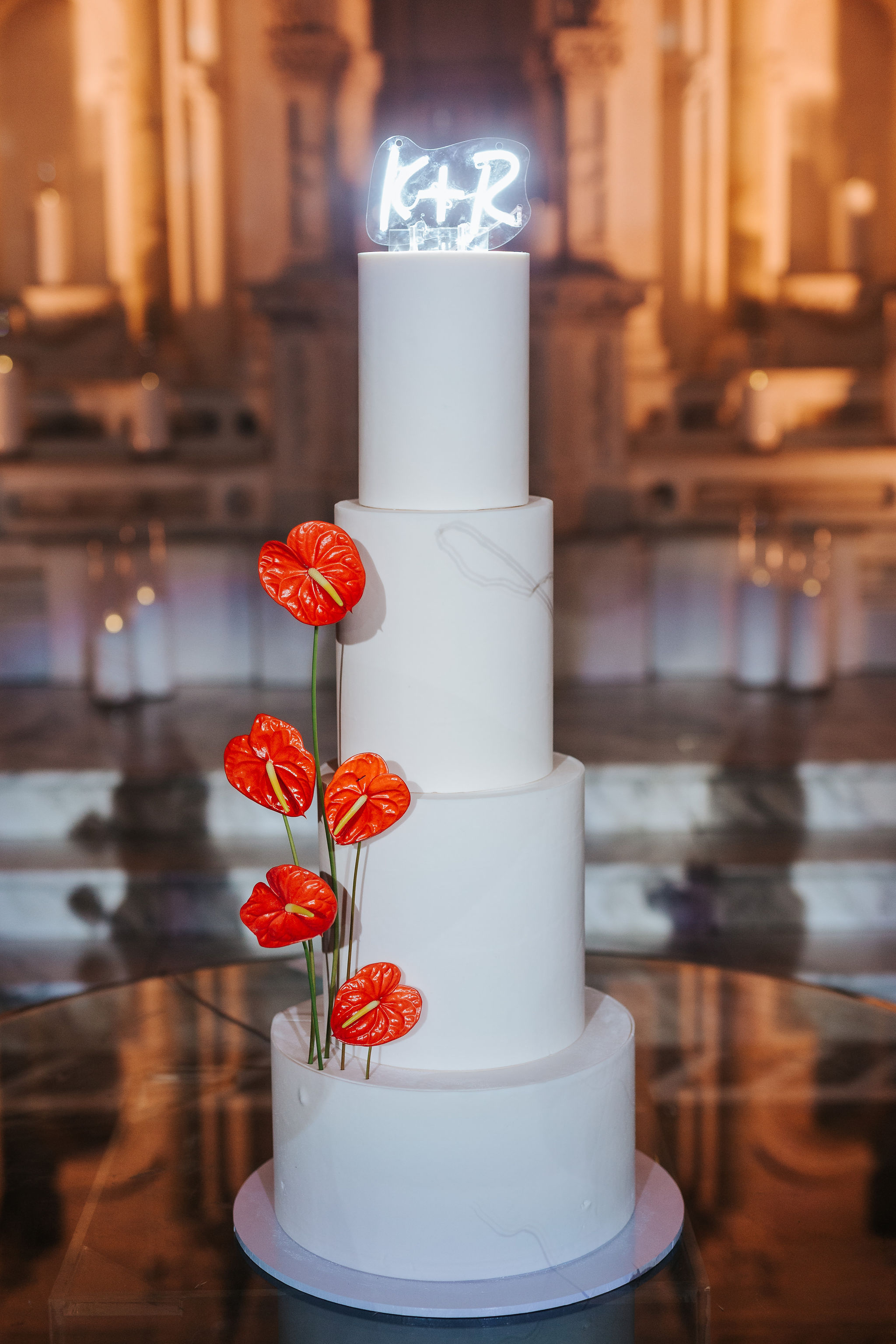 clean white wedding cake with red flowers 