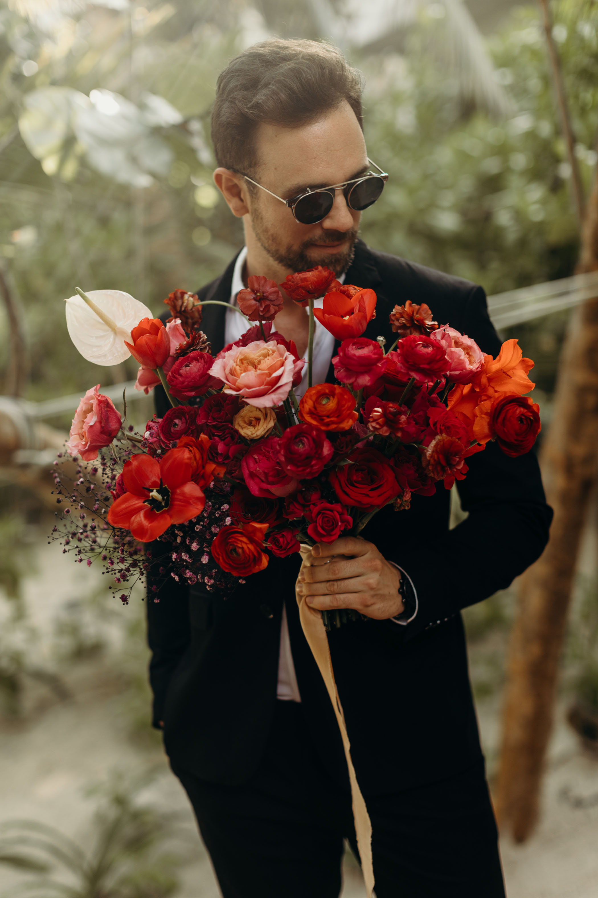 groom with red bouquet