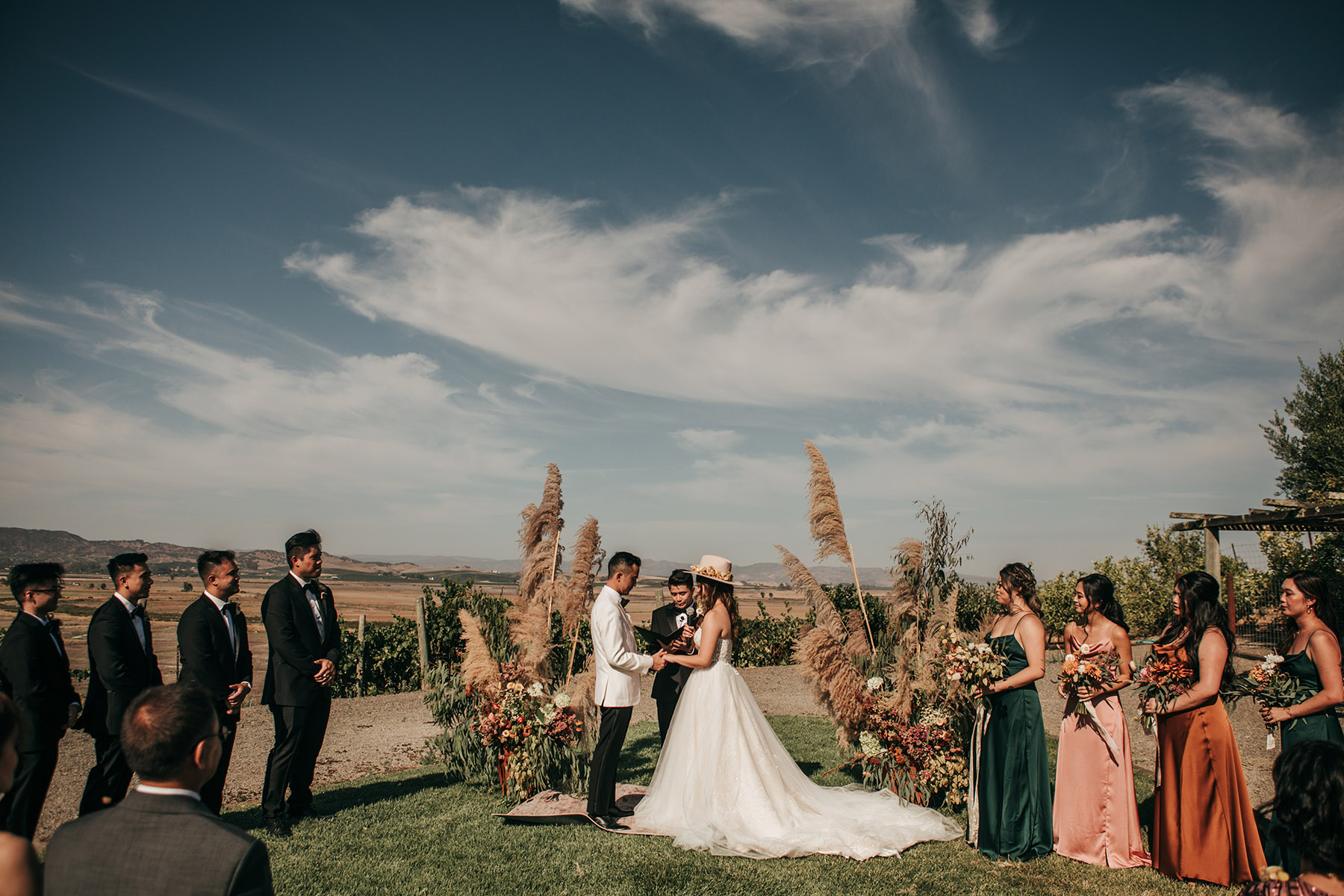 wedding ceremony space with pampas grass bride in boho hat