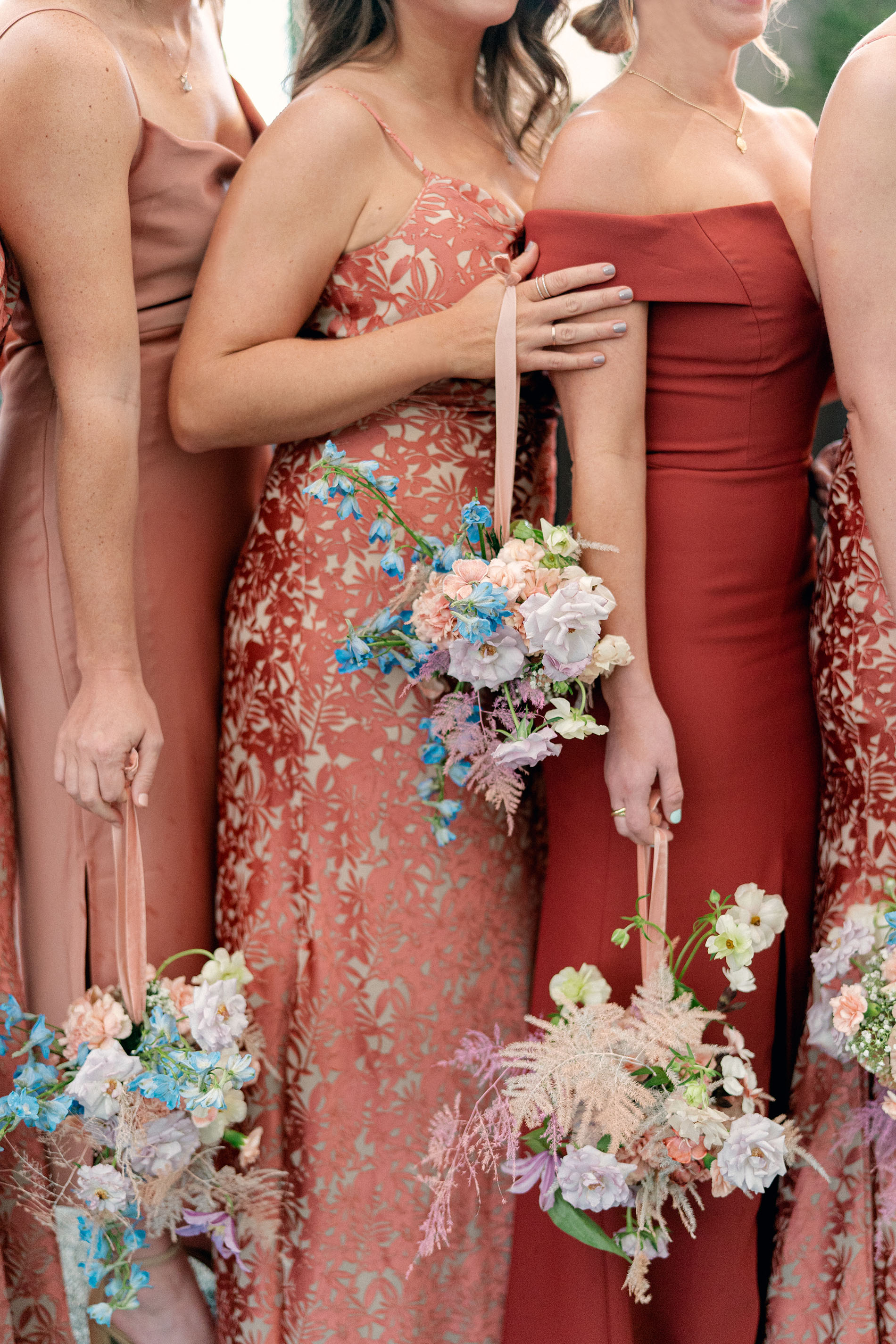 bridesmaids hanging florals with ribbons