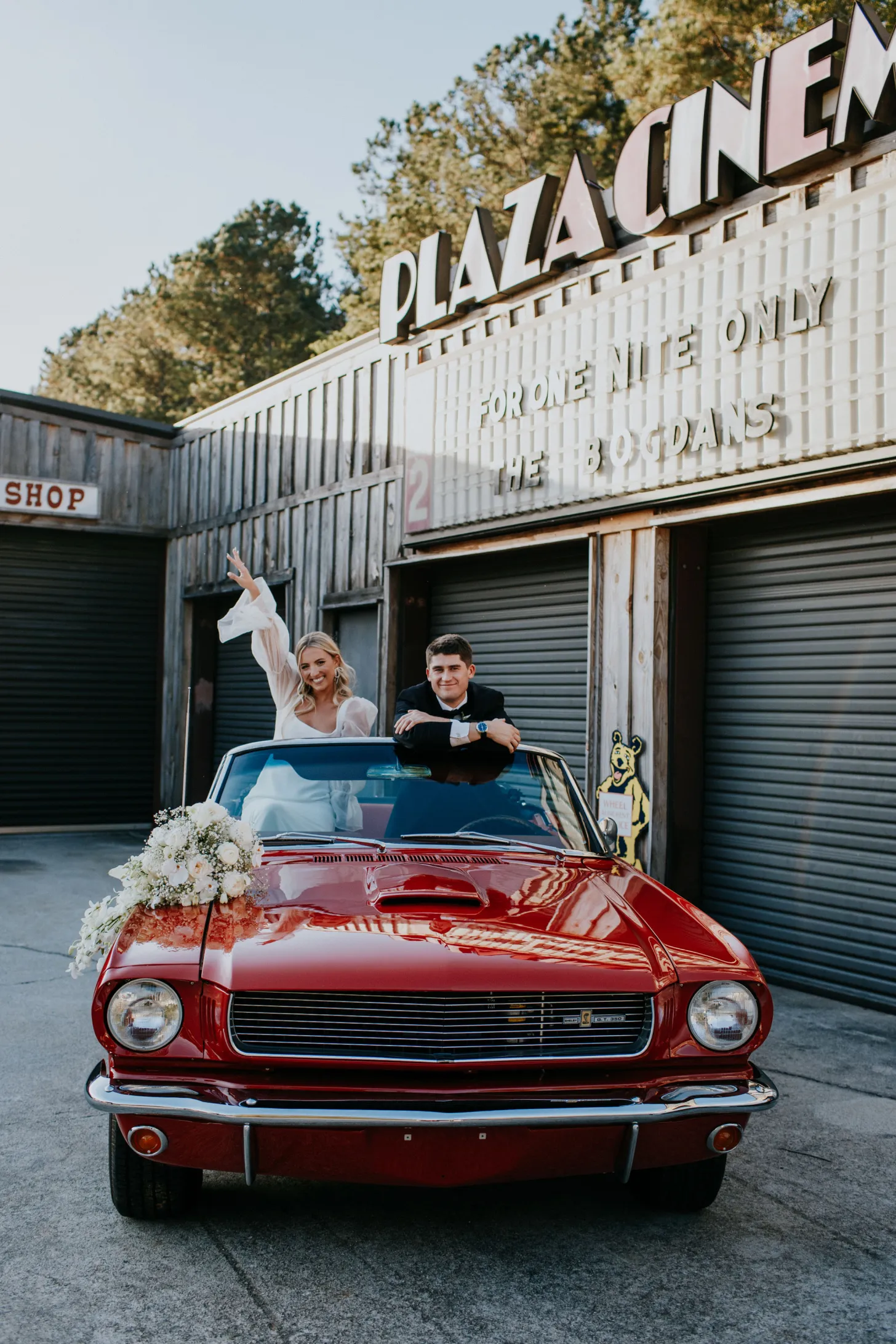 couple arriving to their wedding in a red vintage car they planned to use for their entrance