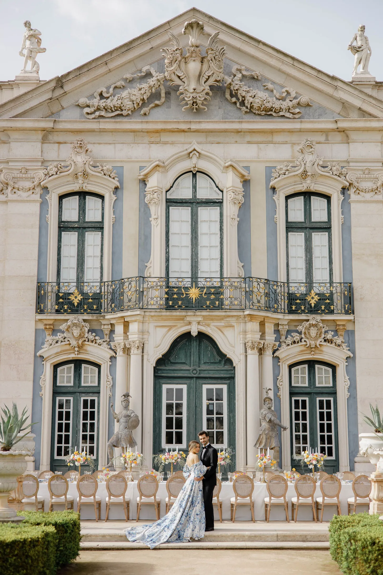 couple standing outside the baby blue palace where they plan to have their wedding
