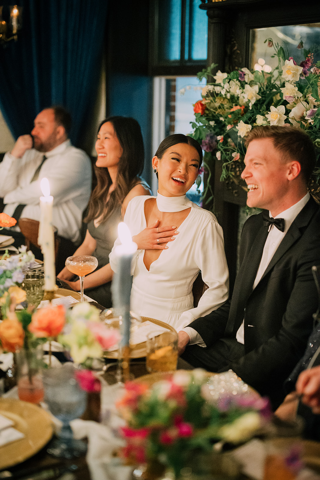 Married couple laughing at a maid of honor speech