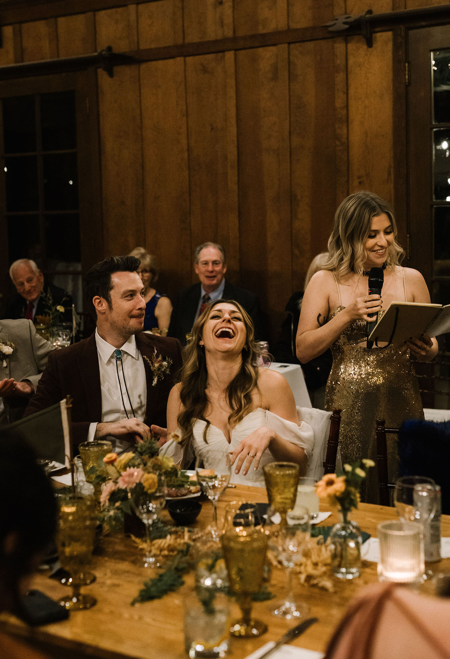 Guests laughing at a maid of honor speech