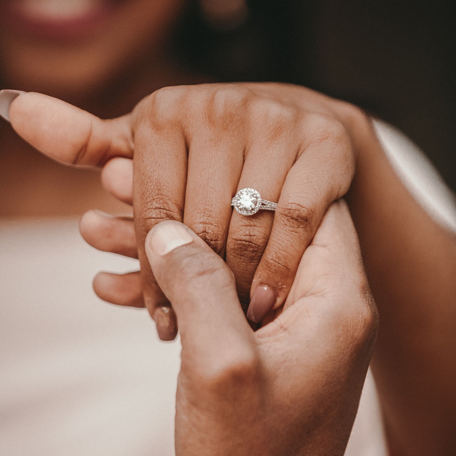 a diamond ring measured and sized to fit perfectly on the ring finger of a woman's left hand
