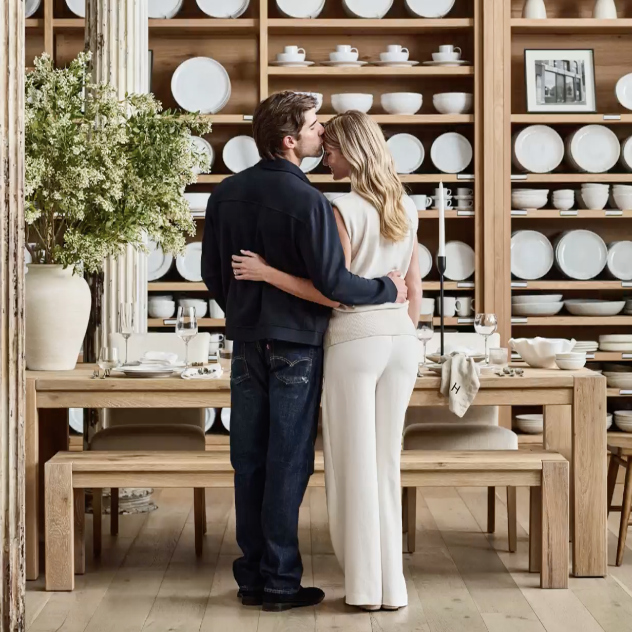 a couple in the dining section of a homeware store choosing the best ideas and must haves to put on their wedding registry checklist