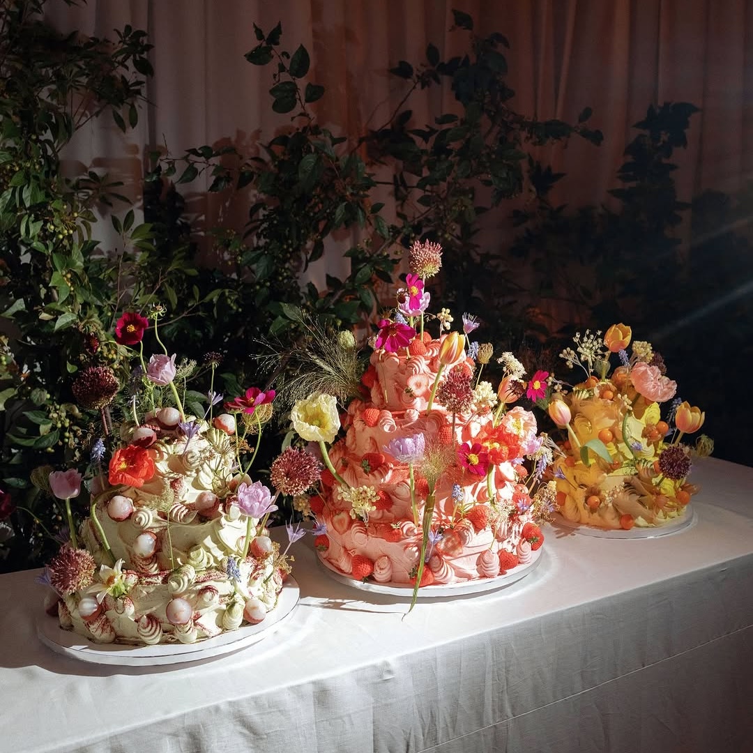 cute chaos cakes ideas featuring pastel pink and green and yellow frosting and maximalist floral and fruit designs