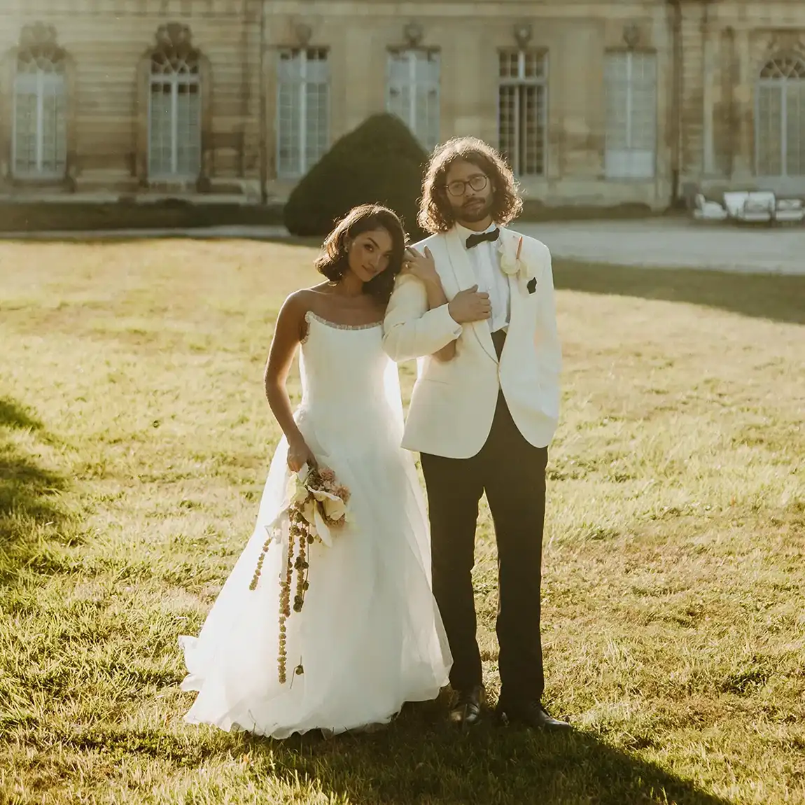 bride and groom in front of their wedding venue