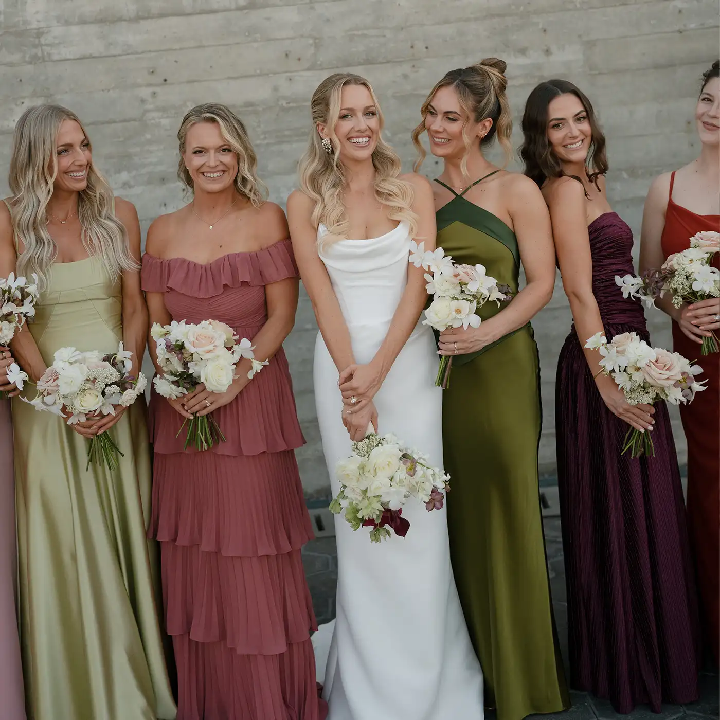 bridesmaids in greens, pink, peach and purple