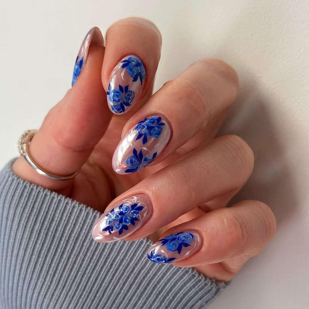 pearlescent manicure with blue rose designs
